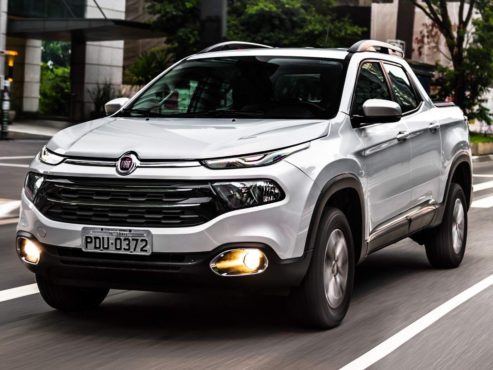 White Fiat Toro pickup truck driving on a city street HD Wallpaper