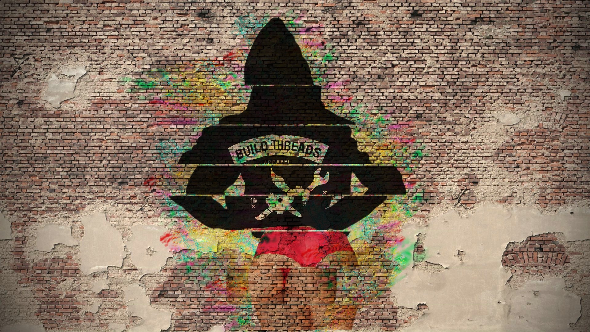 Silhouette of a person with "BUILD THREADS APPAREL" logo on a brick wall HD Wallpaper
