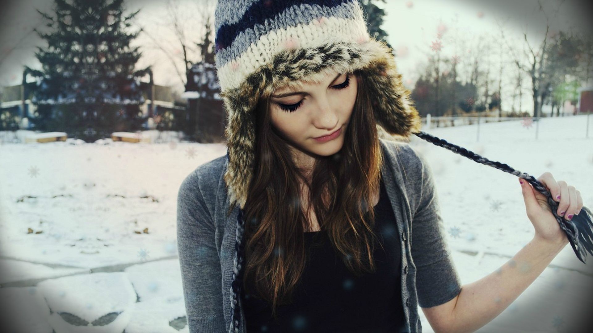 Woman wearing a knit hat in the snow HD Wallpaper