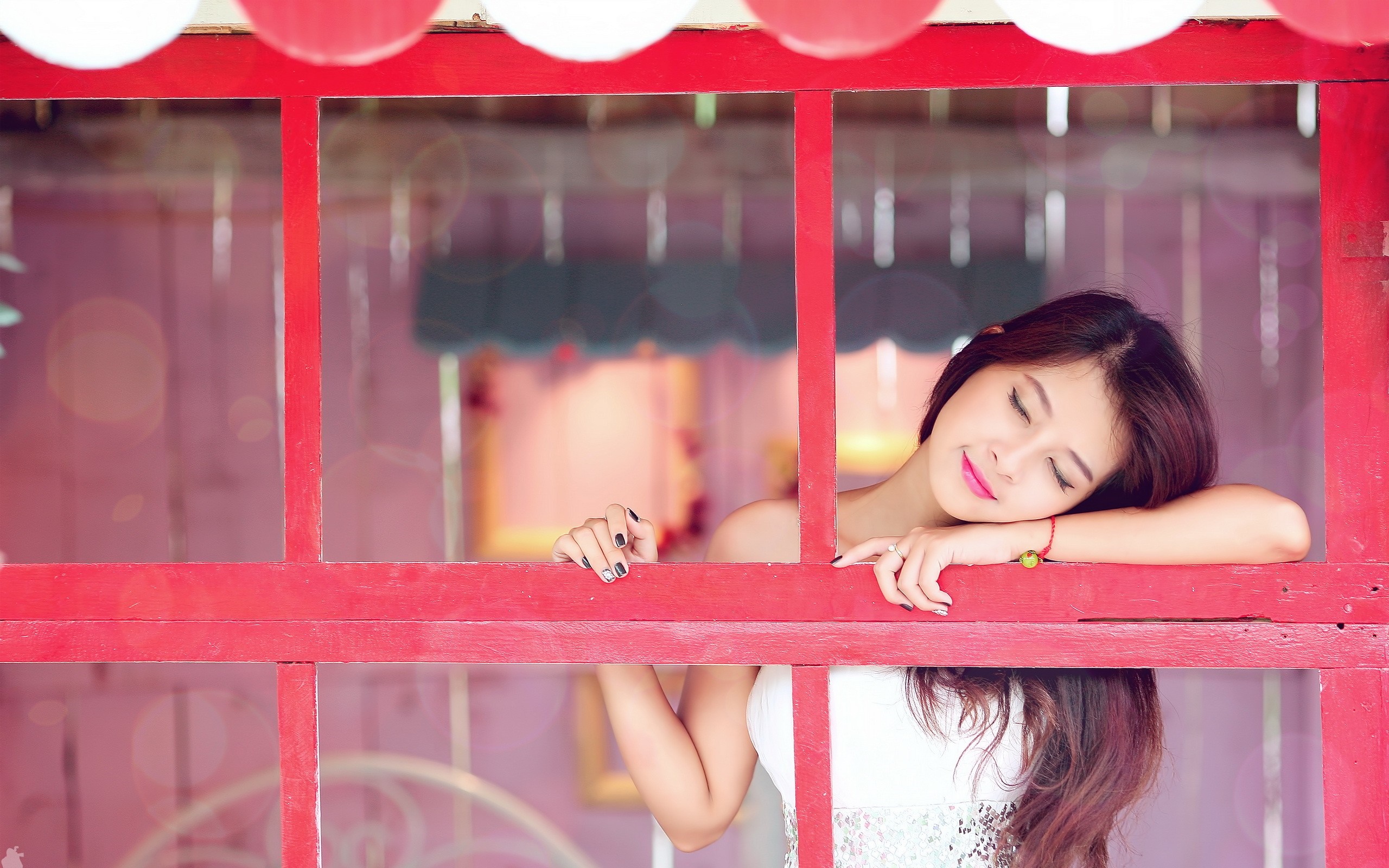 Woman resting her head on a red window frame HD Wallpaper