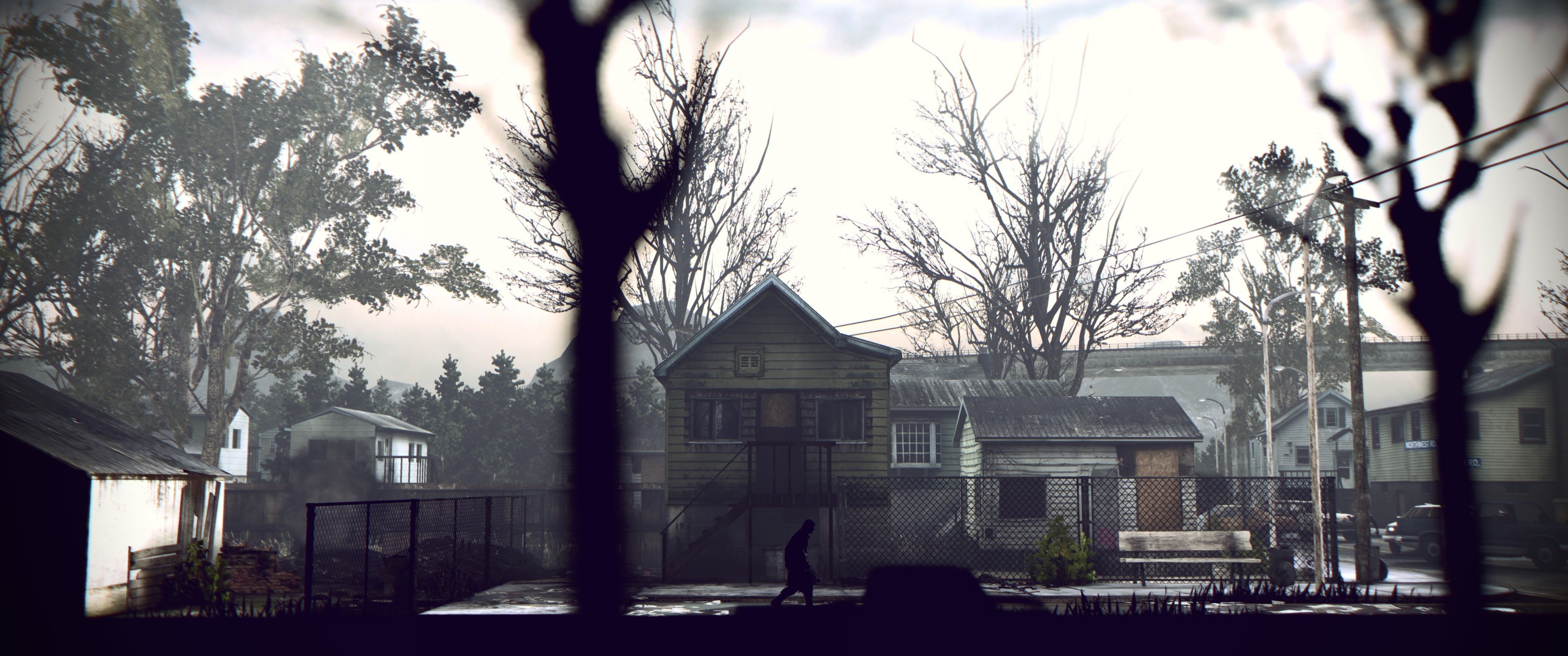 A silhouette walks past houses and trees HD Wallpaper