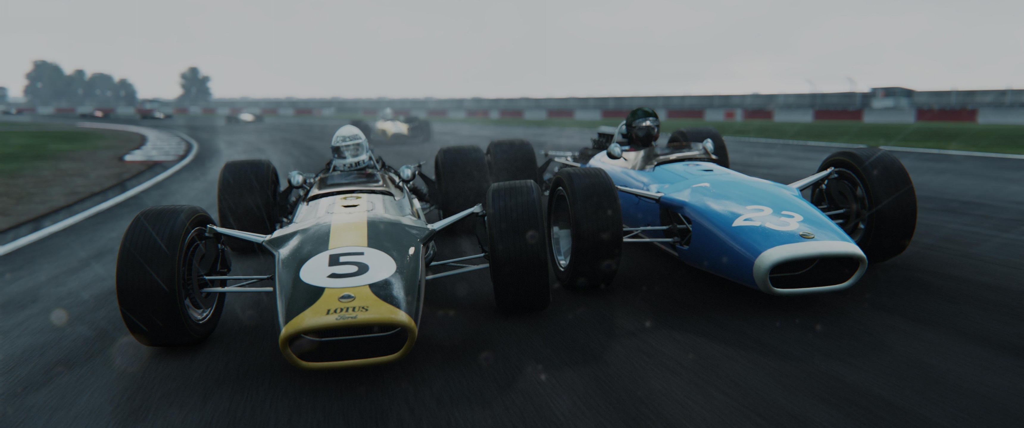 Two vintage Formula 1 cars racing on a wet track HD Wallpaper