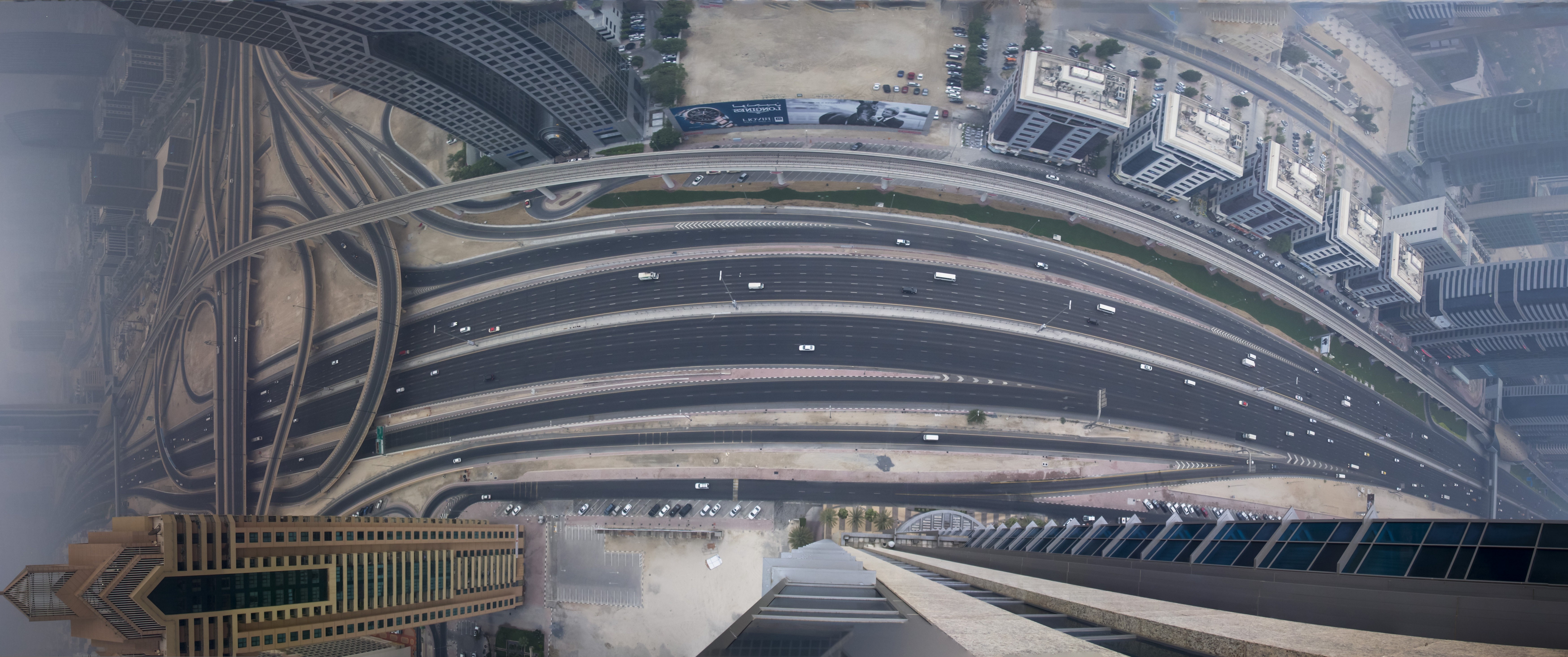 Aerial view of a multi-lane highway interchange in a modern city HD Wallpaper