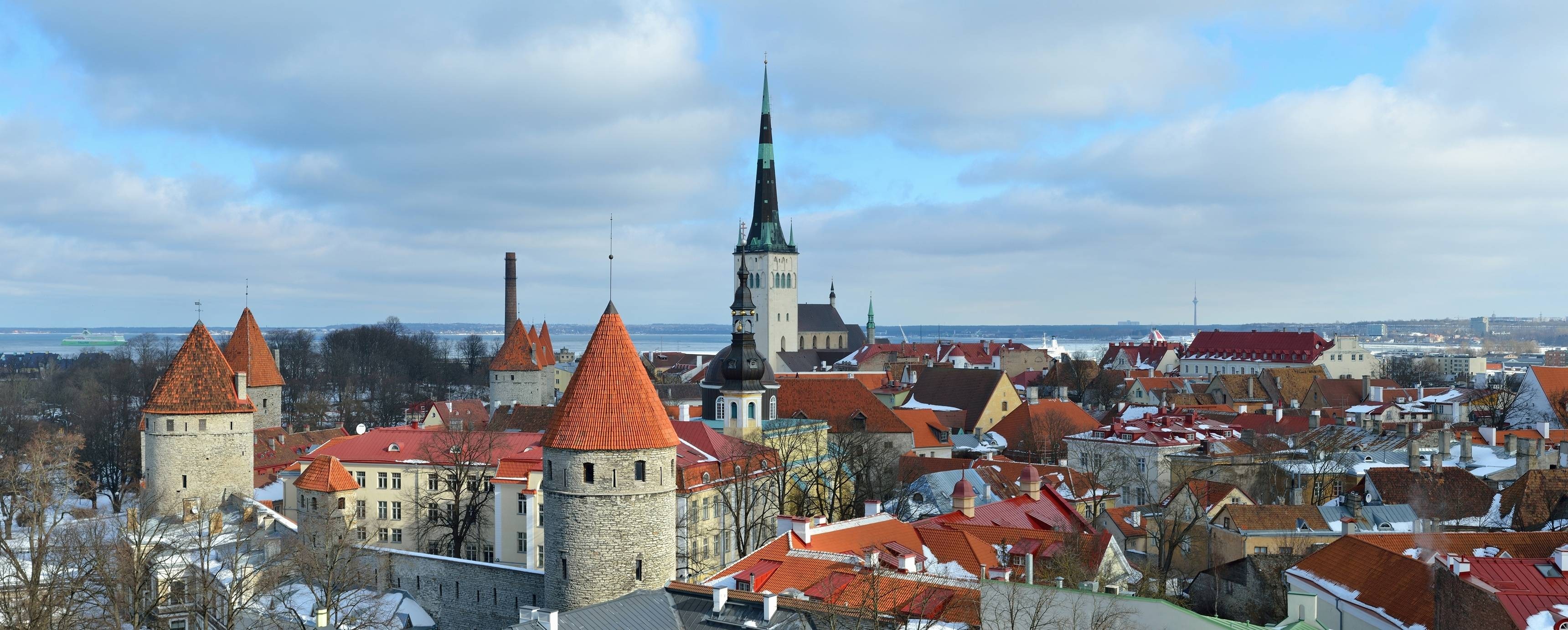 Tallinn Old Town skyline with towers and churches in winter HD Wallpaper