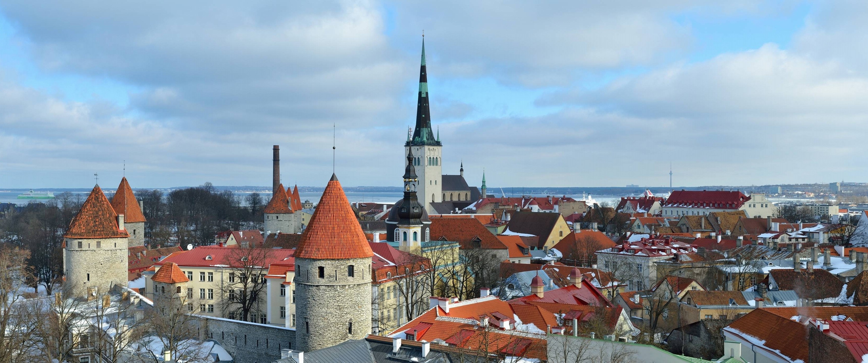Panoramic winter cityscape of Tallinn with towers and churches HD Wallpaper