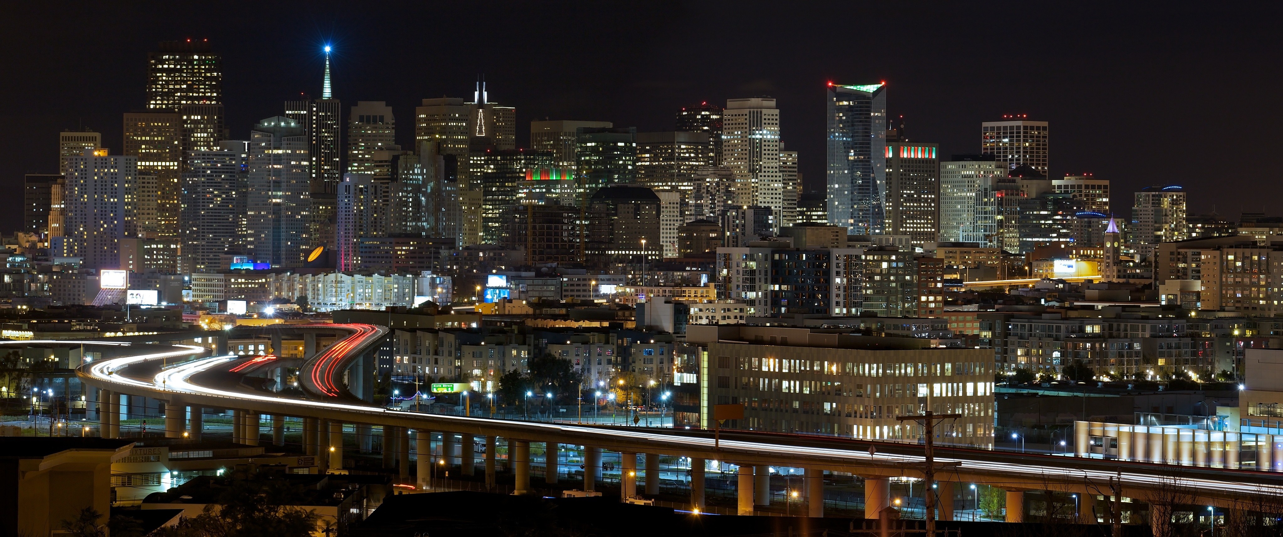 San Francisco cityscape at night with light trails on highway HD Wallpaper