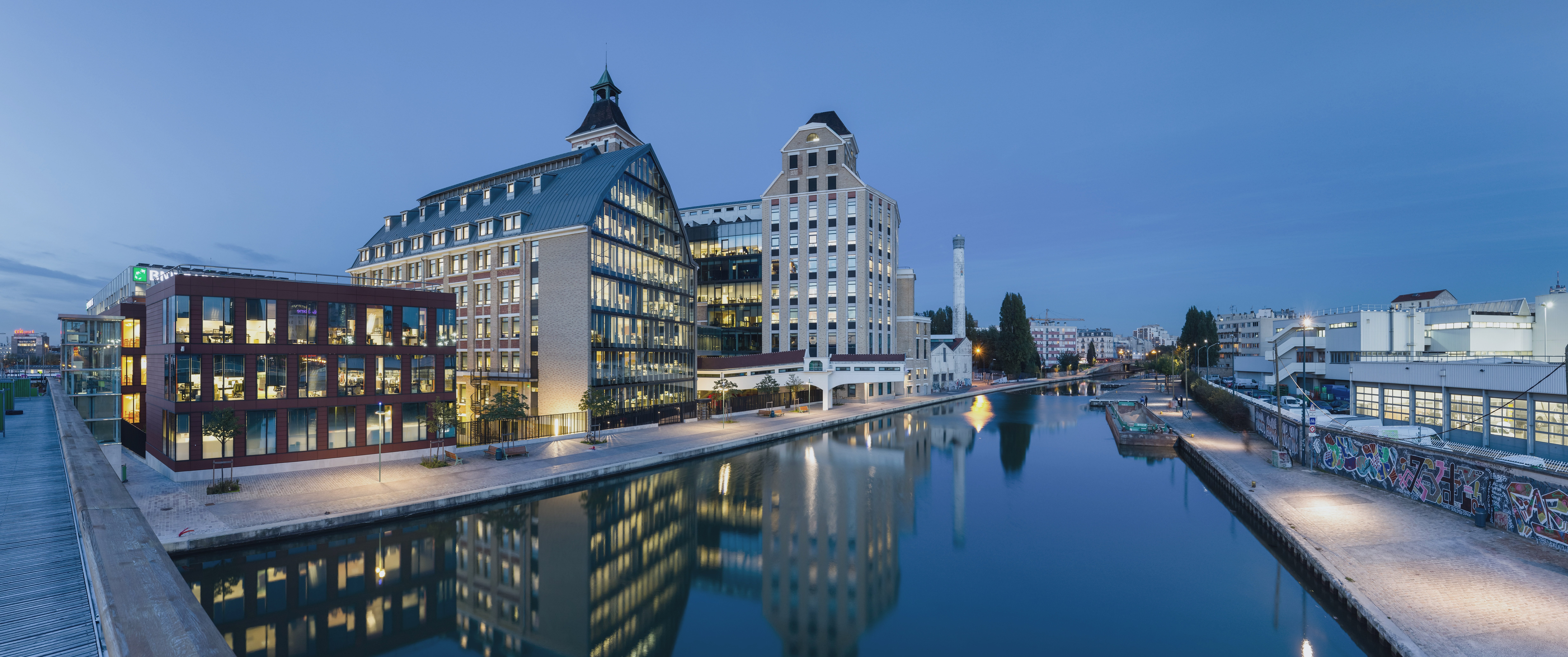 Modern buildings along a canal at dusk HD Wallpaper