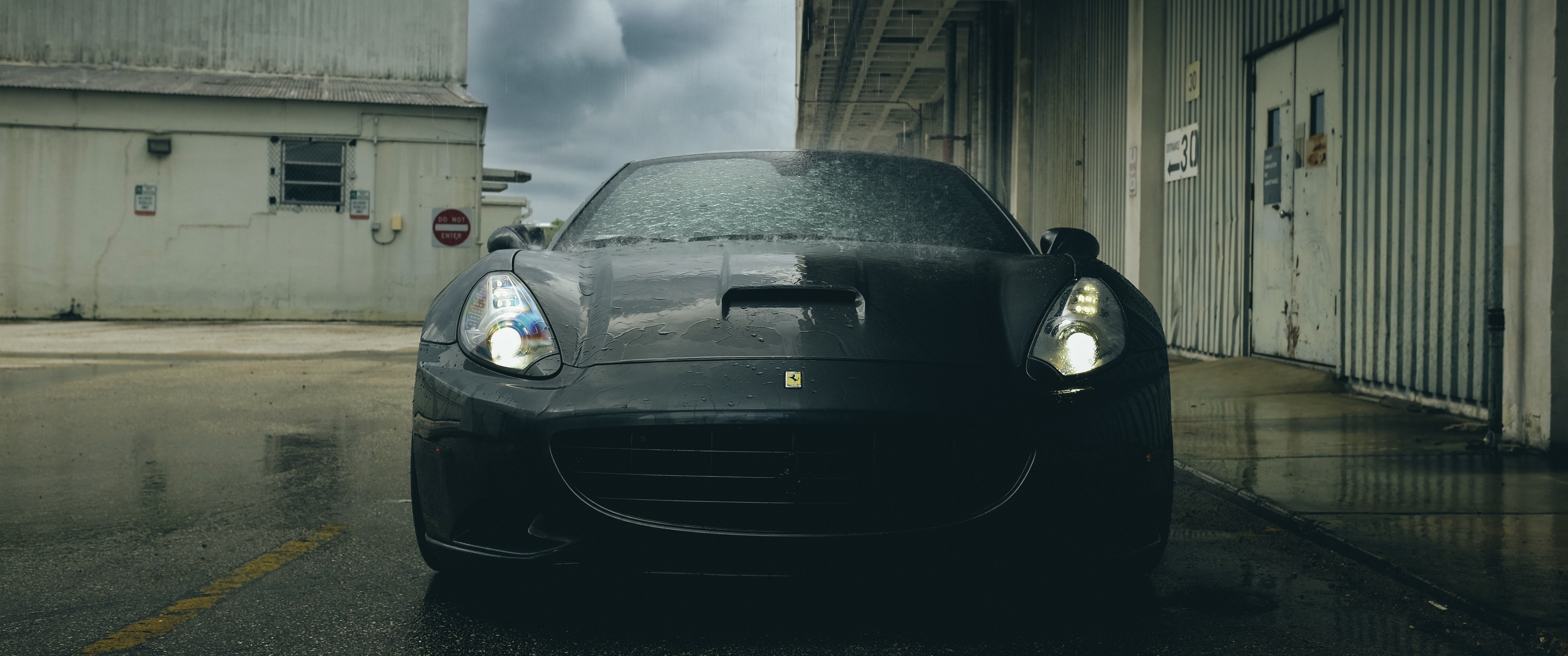 Black Ferrari sports car on wet asphalt HD Wallpaper
