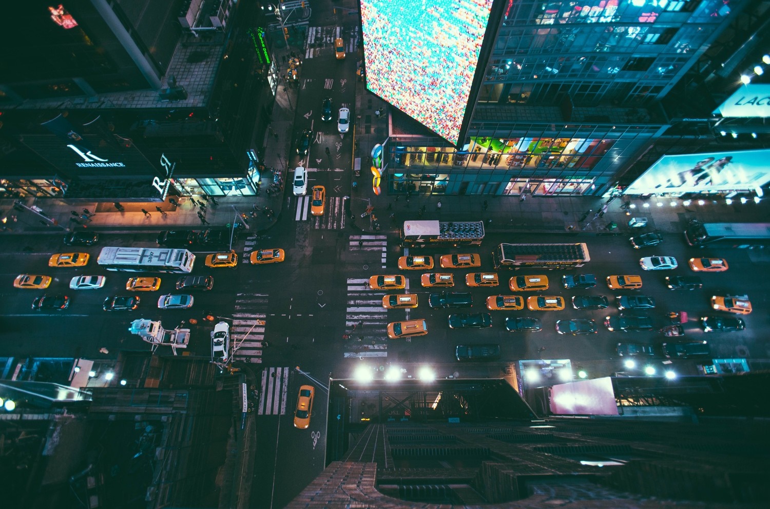 Aerial view of a busy city street at night with traffic HD Wallpaper