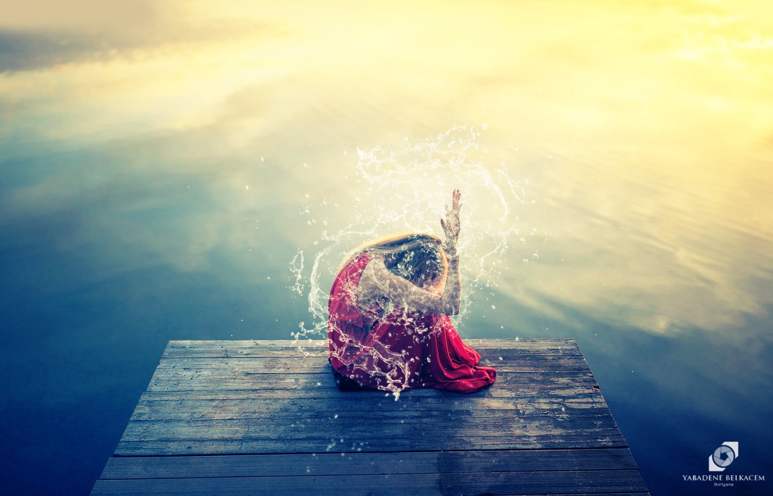 Woman in red dress on dock with water splashes HD Wallpaper