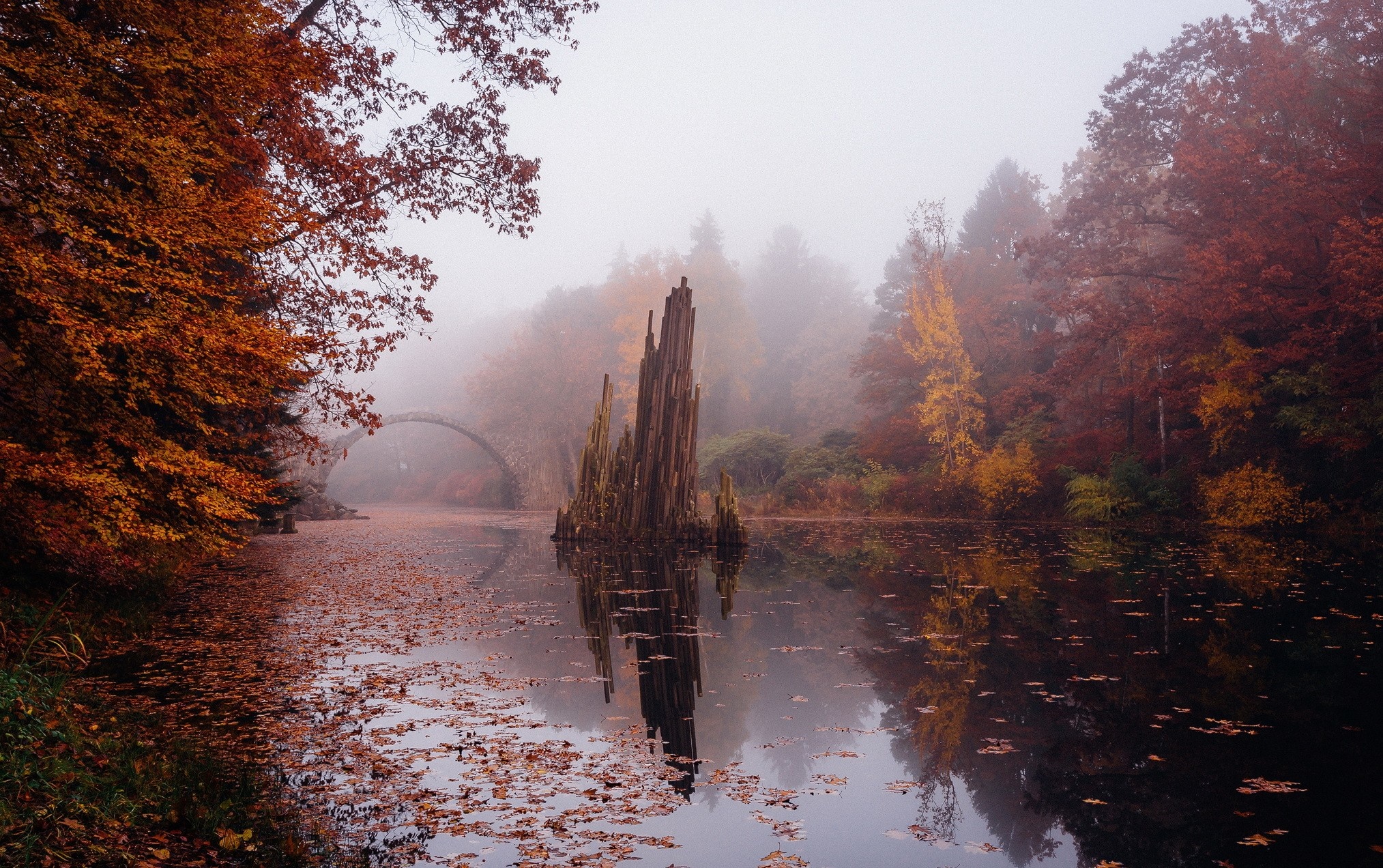 Rakotzsee bridge and rock formation in autumn fog HD Wallpaper