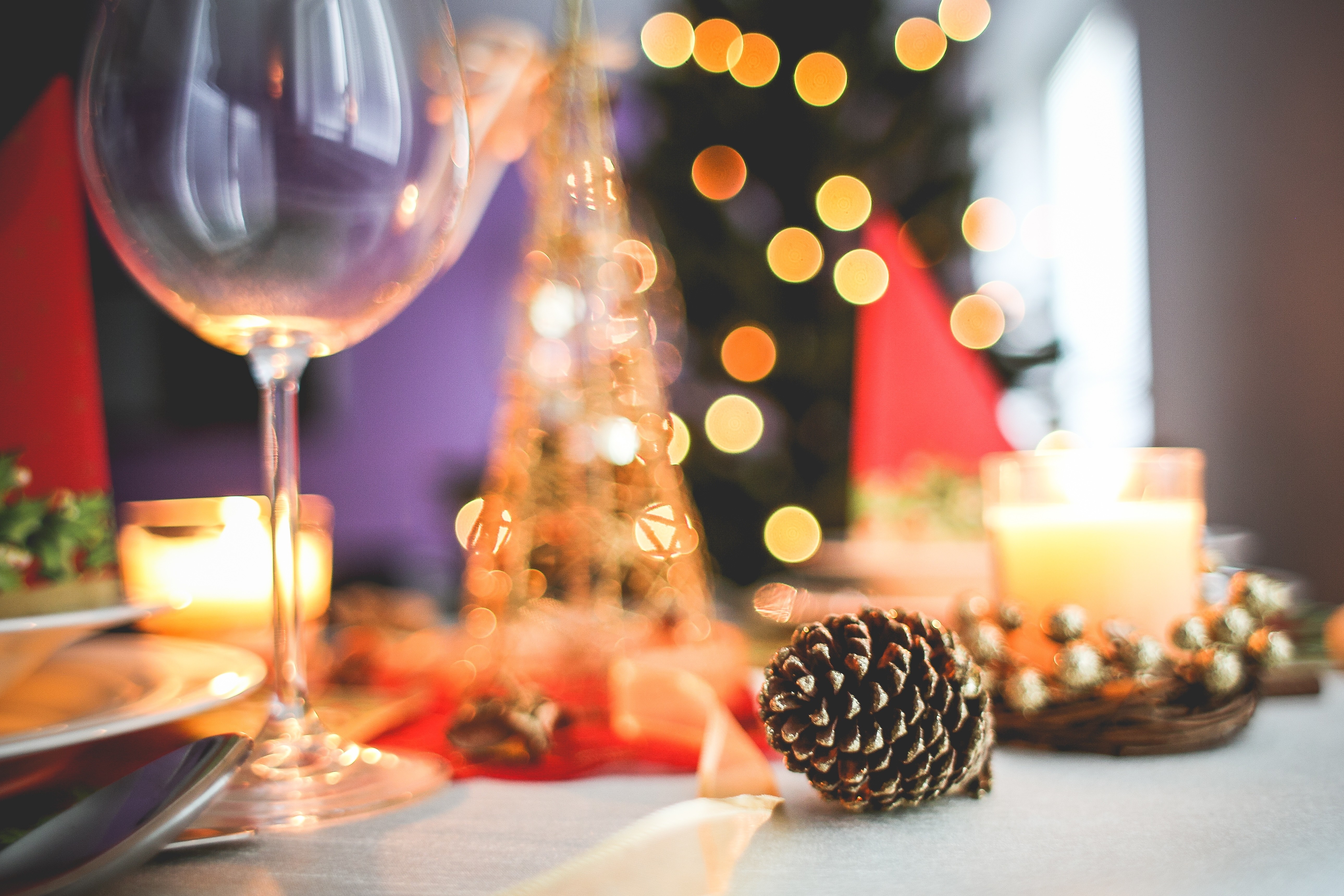 Christmas table setting with candles and pine cone HD Wallpaper