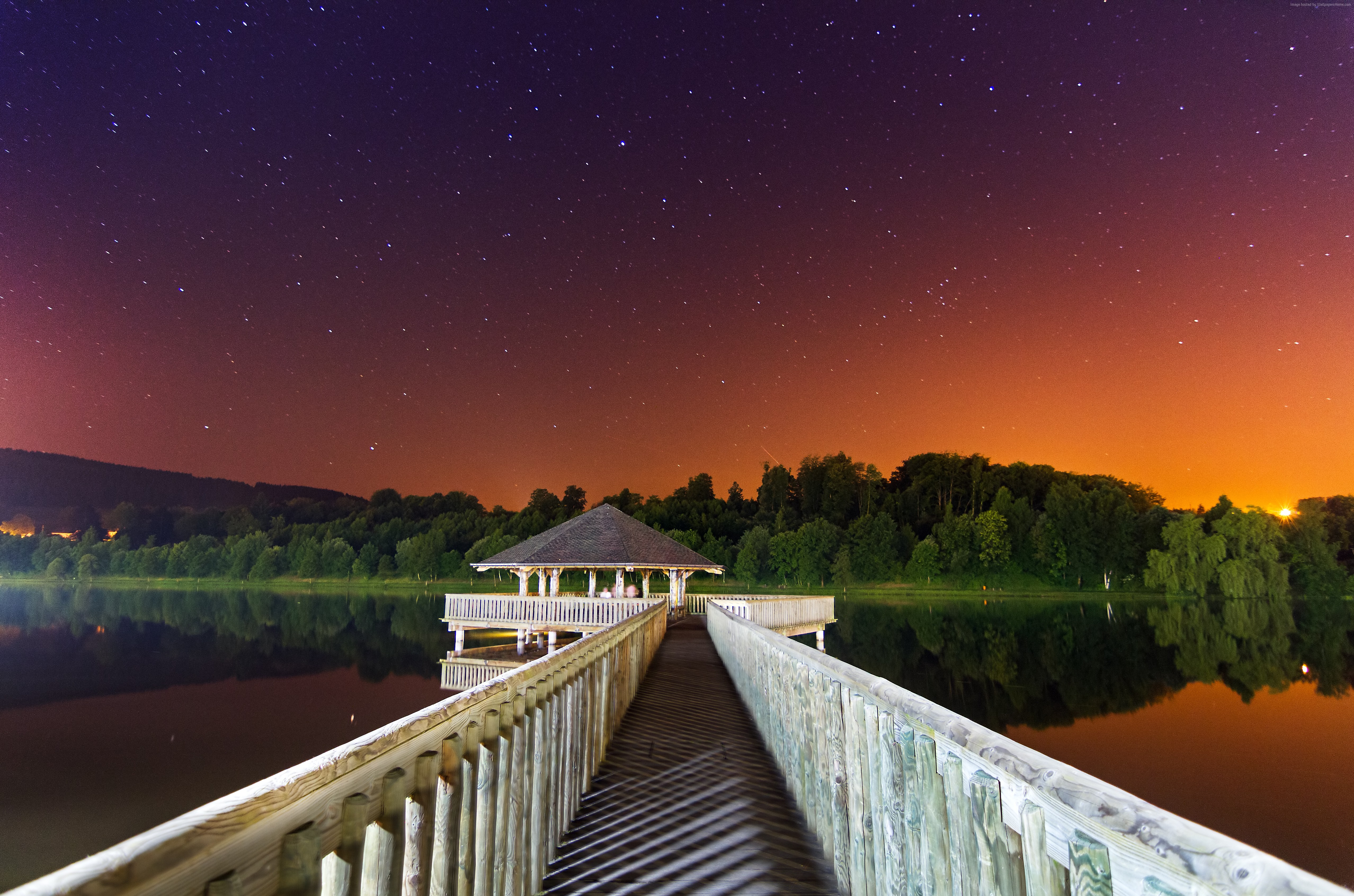 Wooden pier and gazebo under starry night sky over lake HD Wallpaper