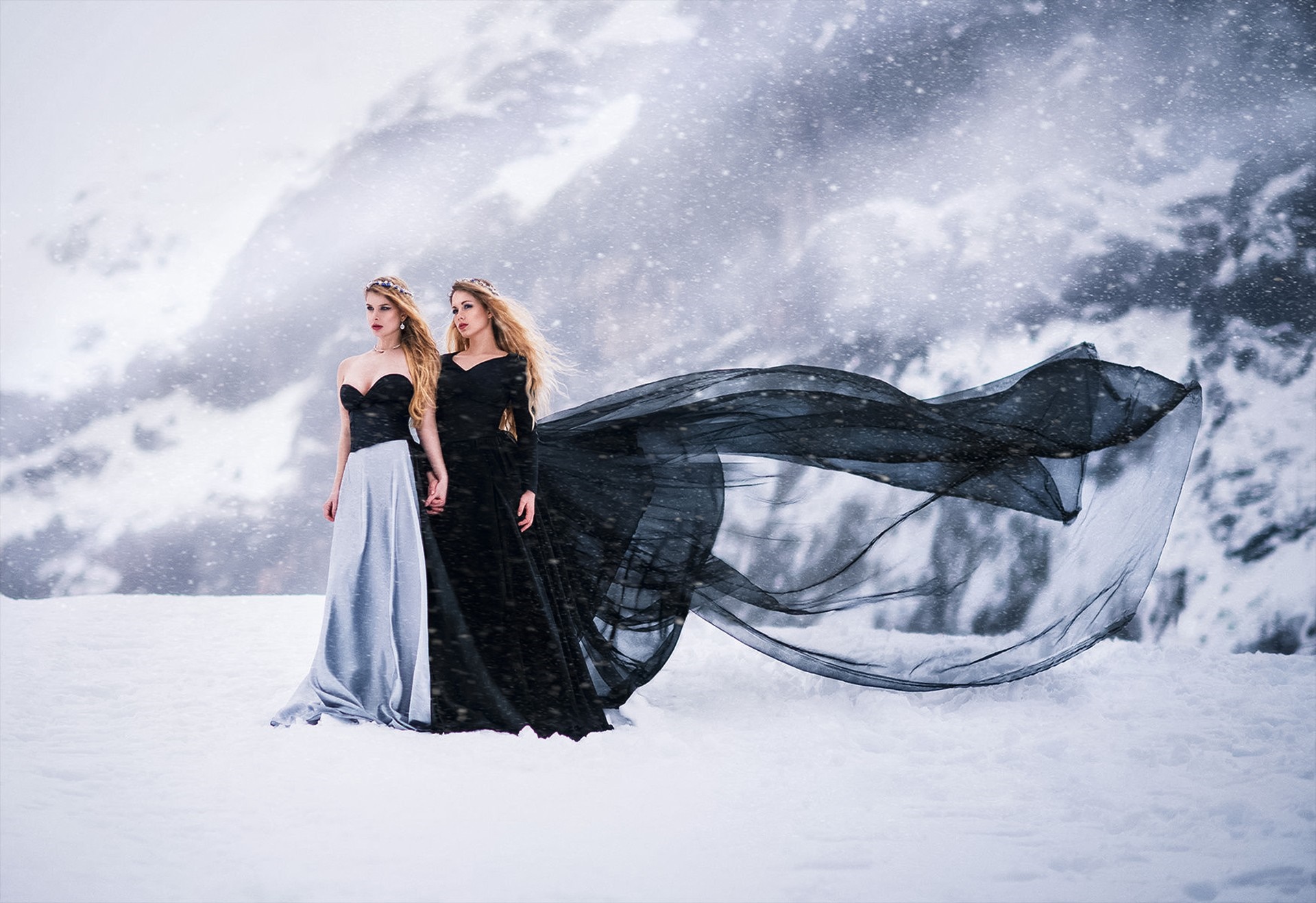 Two women in formal dresses in a snowy landscape HD Wallpaper