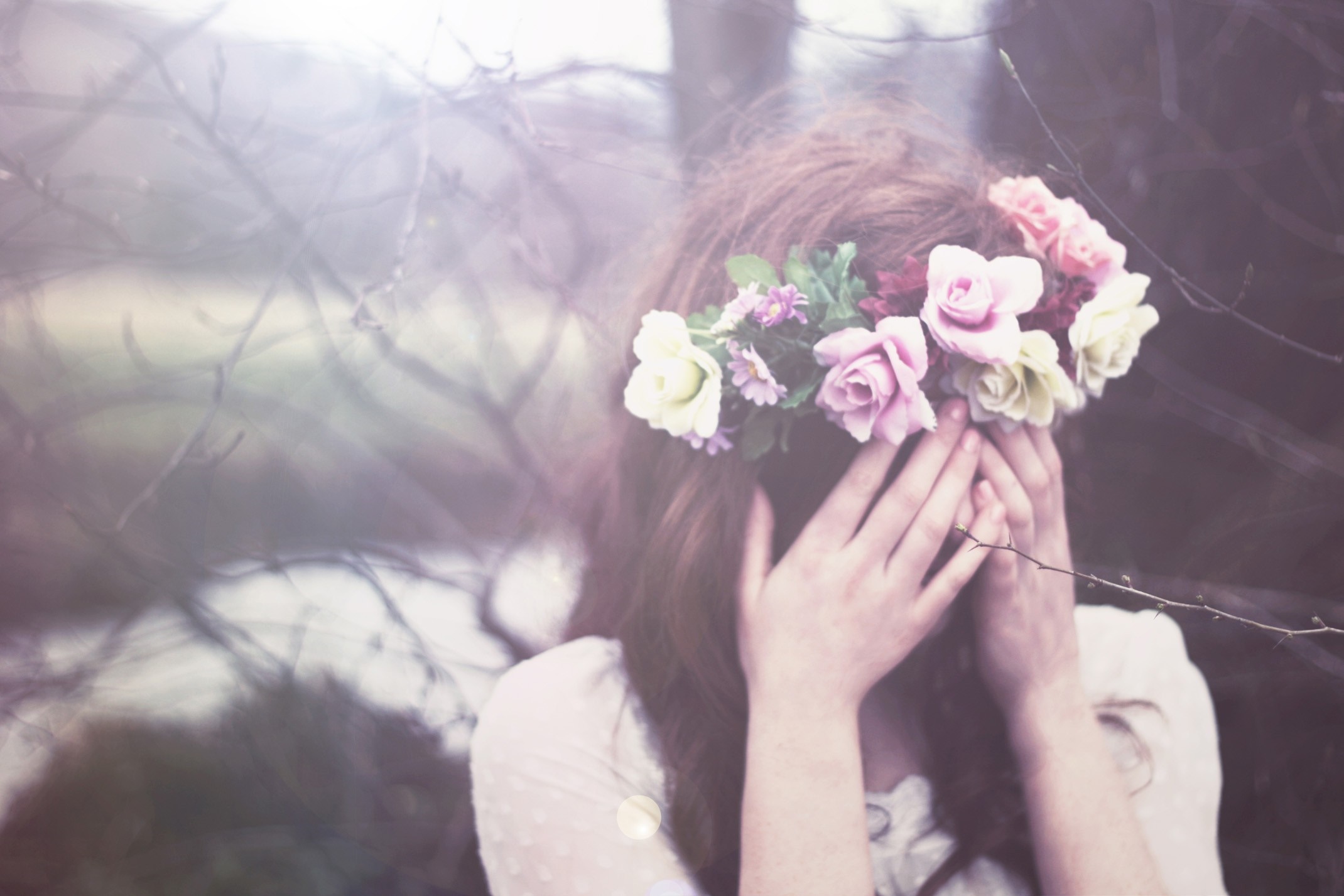 Woman with flower crown covering face outdoors HD Wallpaper