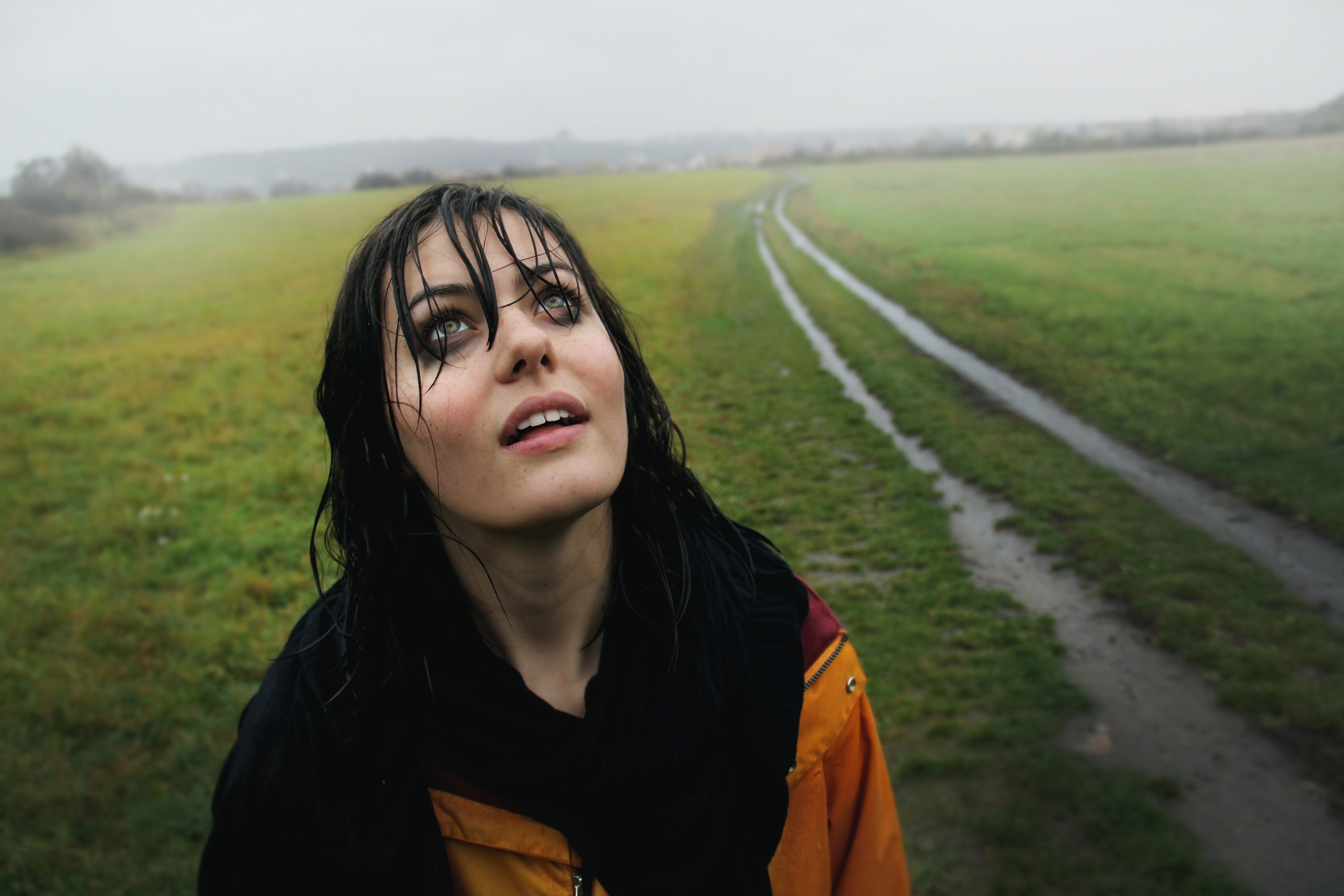 Woman with wet hair looking up in a field HD Wallpaper