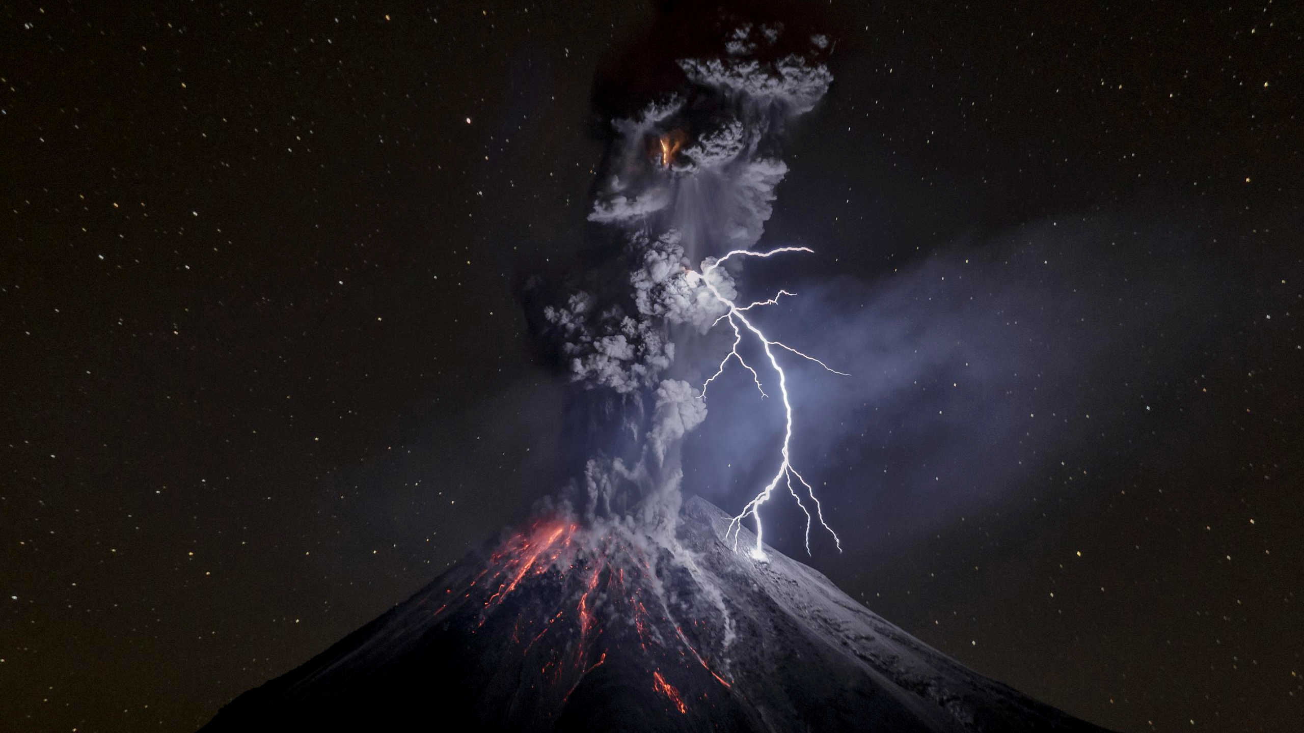 Volcanic eruption with lightning at night HD Wallpaper