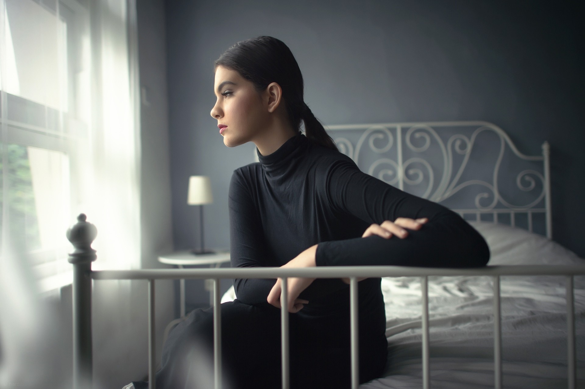 Woman in black turtleneck sitting on a bed HD Wallpaper