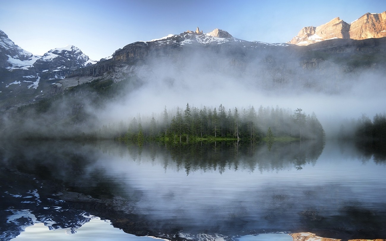 Misty lake with pine trees and snow-capped mountains HD Wallpaper
