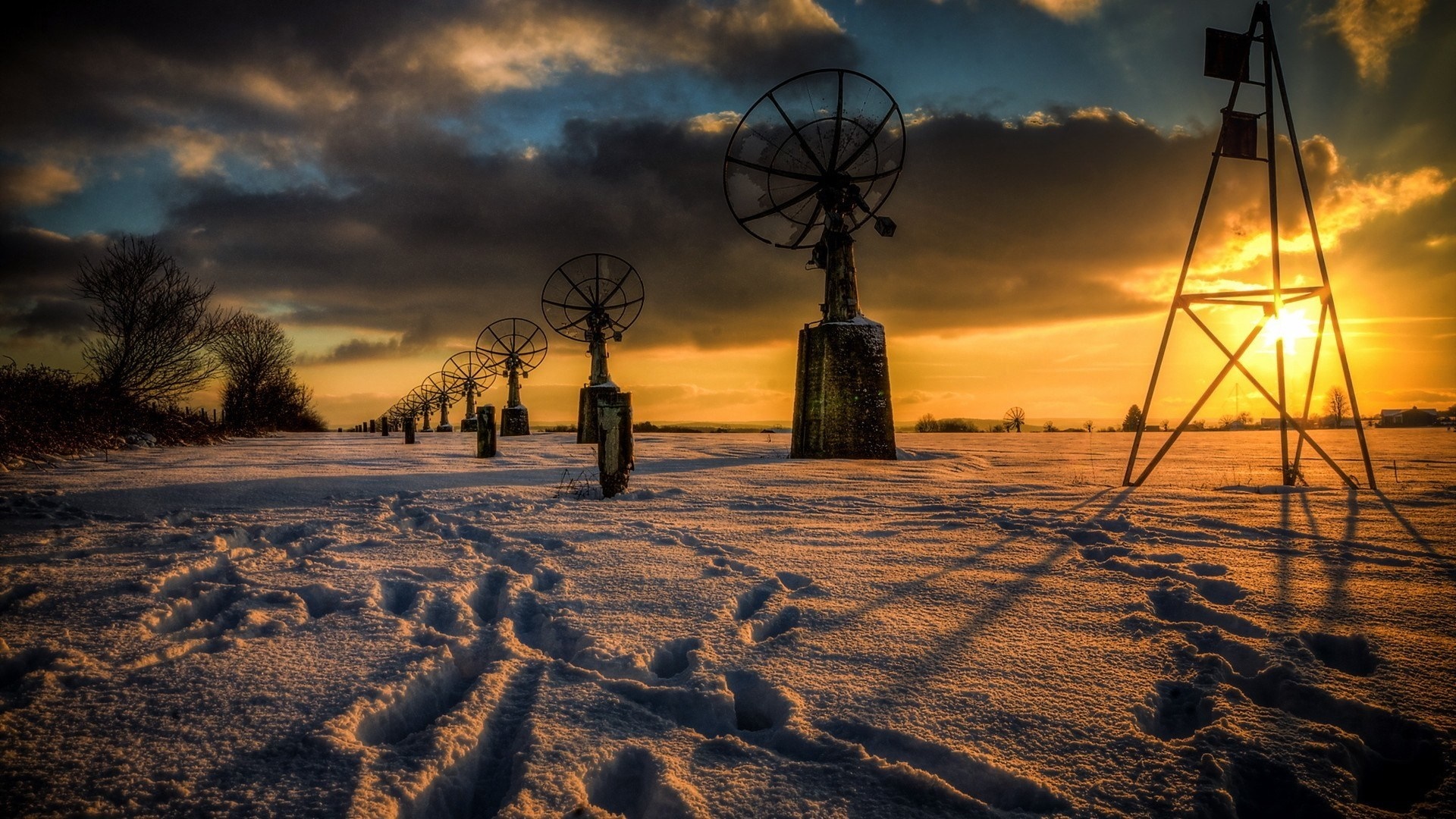 Snowy field with radio antennas at sunset HD Wallpaper