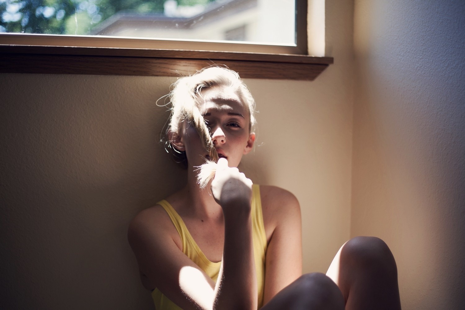 Woman with hair in face by window HD Wallpaper