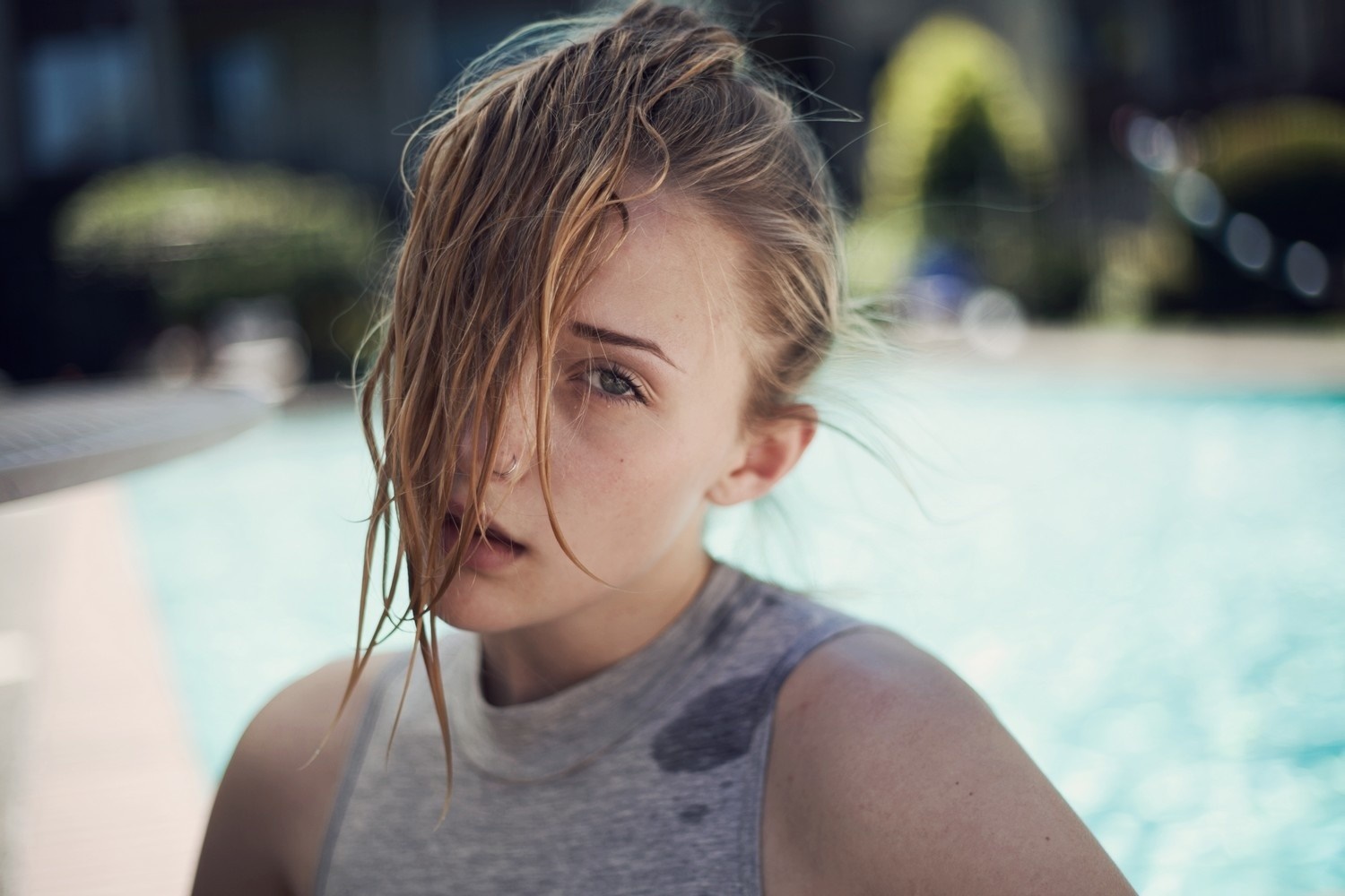 Portrait of a young woman with wet hair by a pool HD Wallpaper