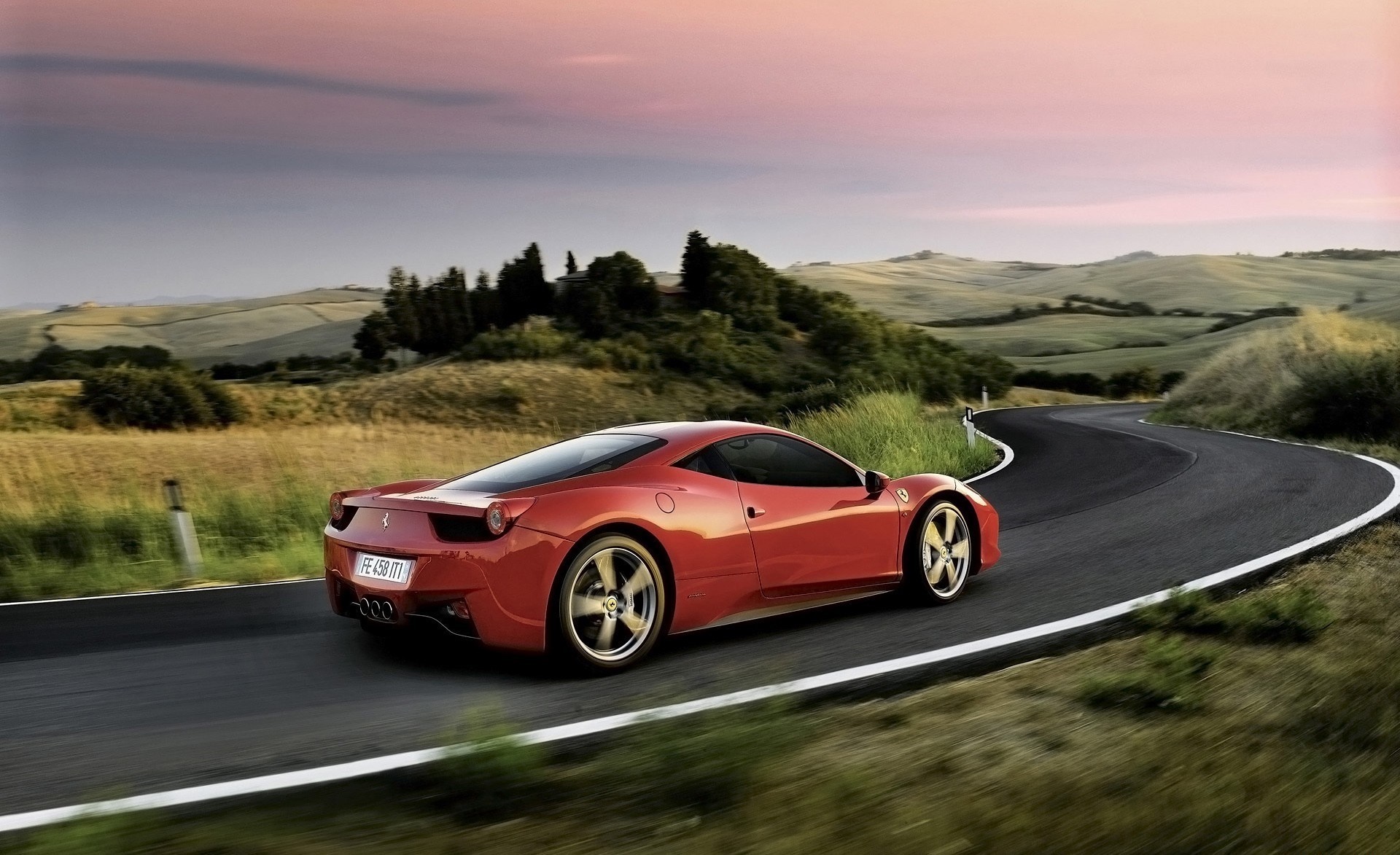 Red Ferrari 458 Italia driving on a winding road HD Wallpaper