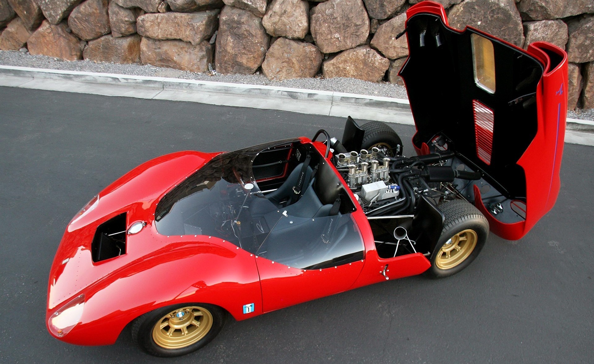 Red vintage sports car with open hood and engine HD Wallpaper