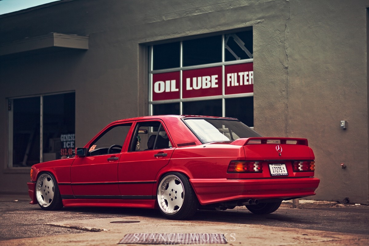 Red Mercedes-Benz 190E 2.3-16 parked outside auto shop HD Wallpaper