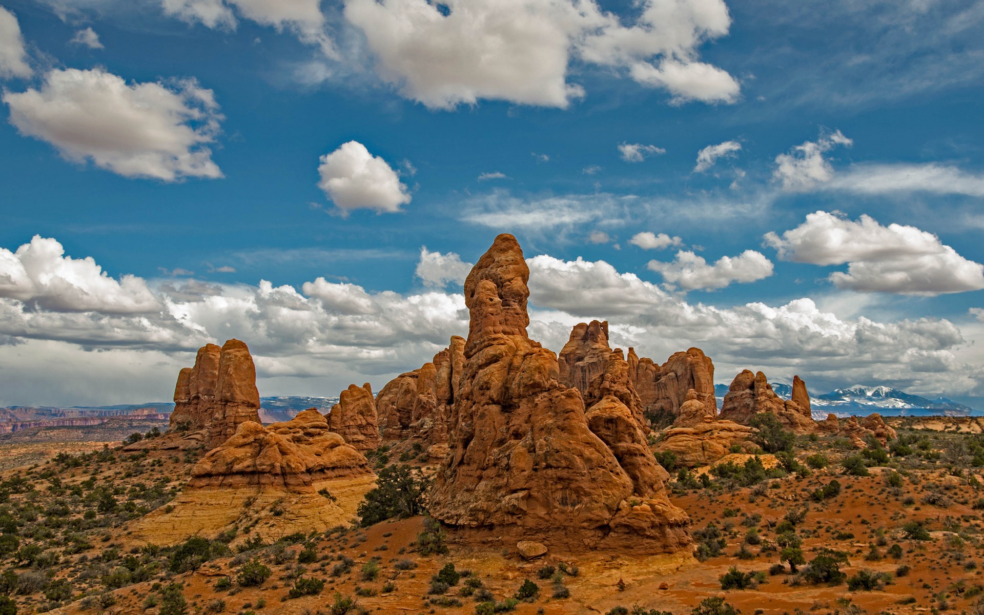 Desert landscape with rock formations and clouds HD Wallpaper