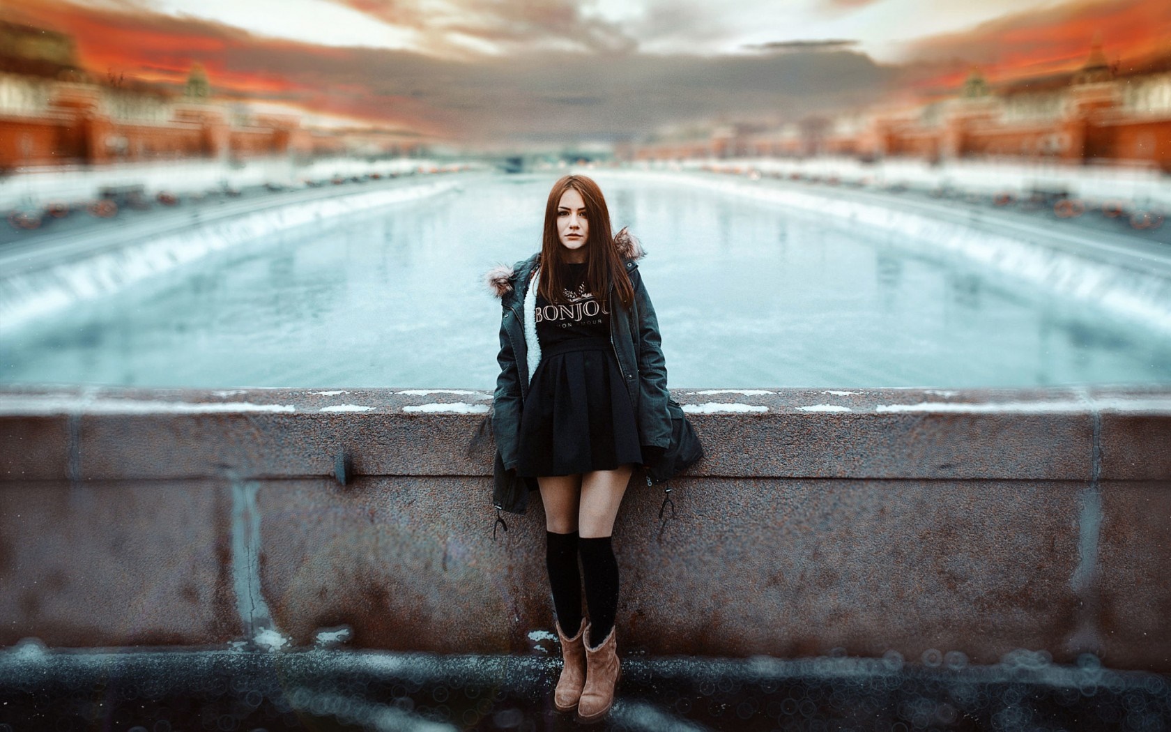 Woman in black dress and coat standing by a frozen river HD Wallpaper
