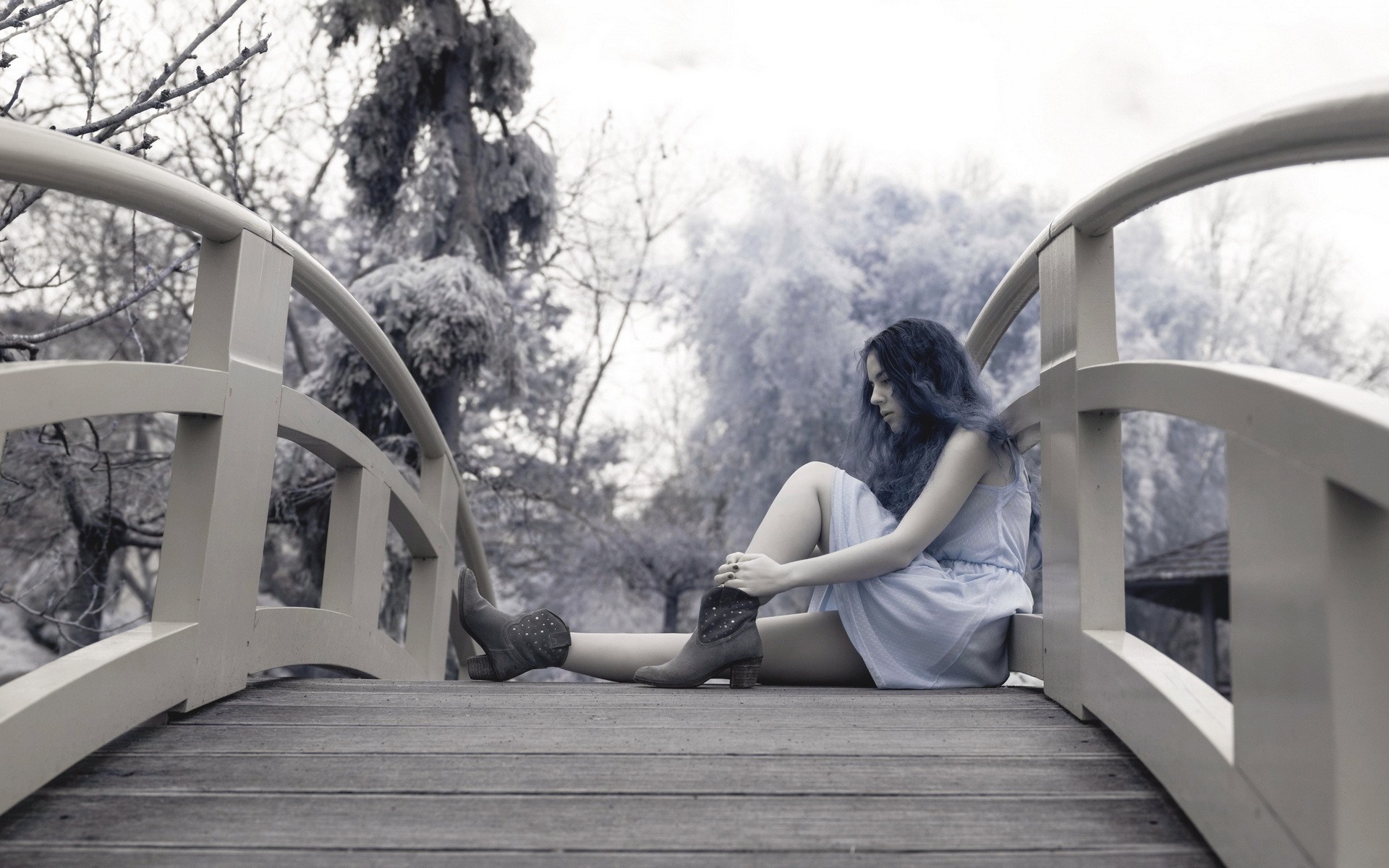 Woman sitting on a bridge in winter HD Wallpaper