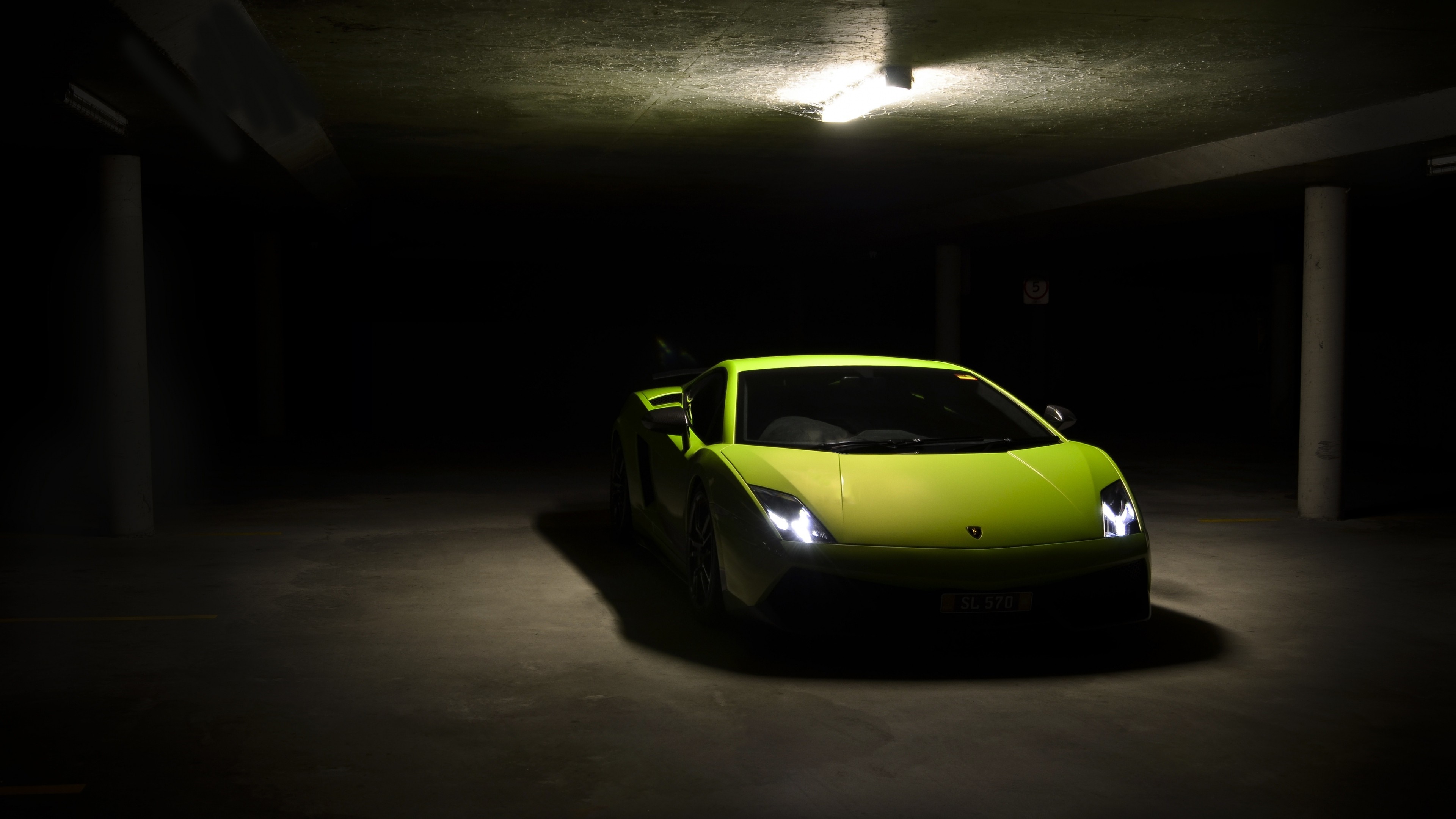 Lime green Lamborghini Gallardo in a dark parking garage HD Wallpaper
