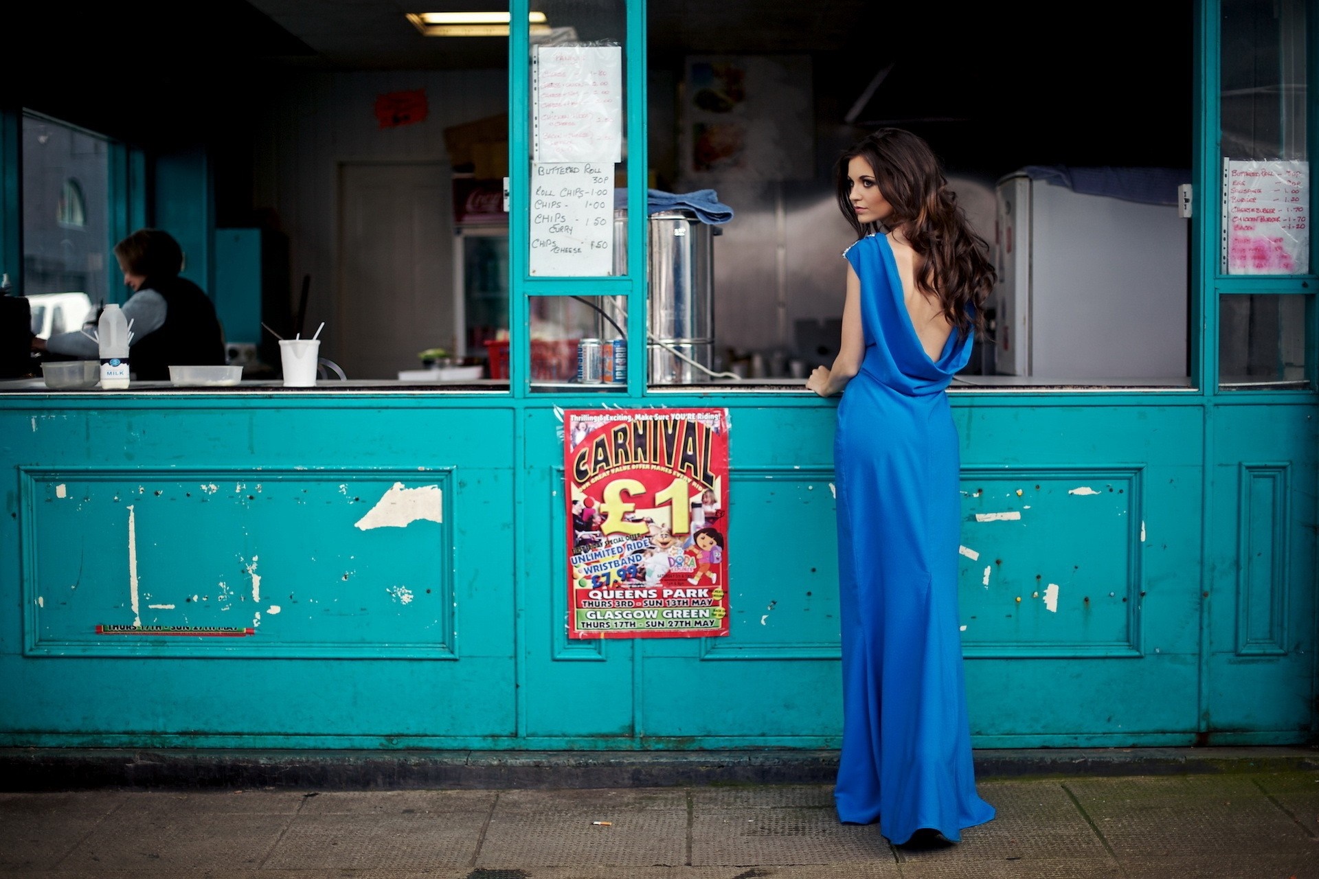 Woman in blue dress at a food stand HD Wallpaper