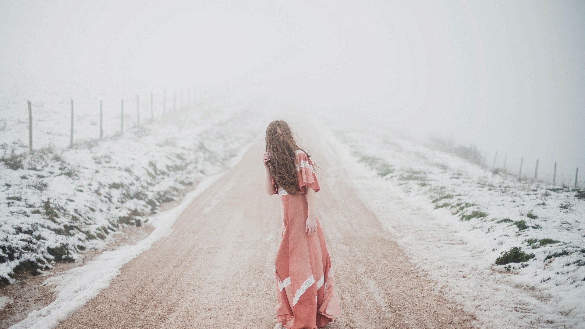 Woman in dress on snowy road HD Wallpaper