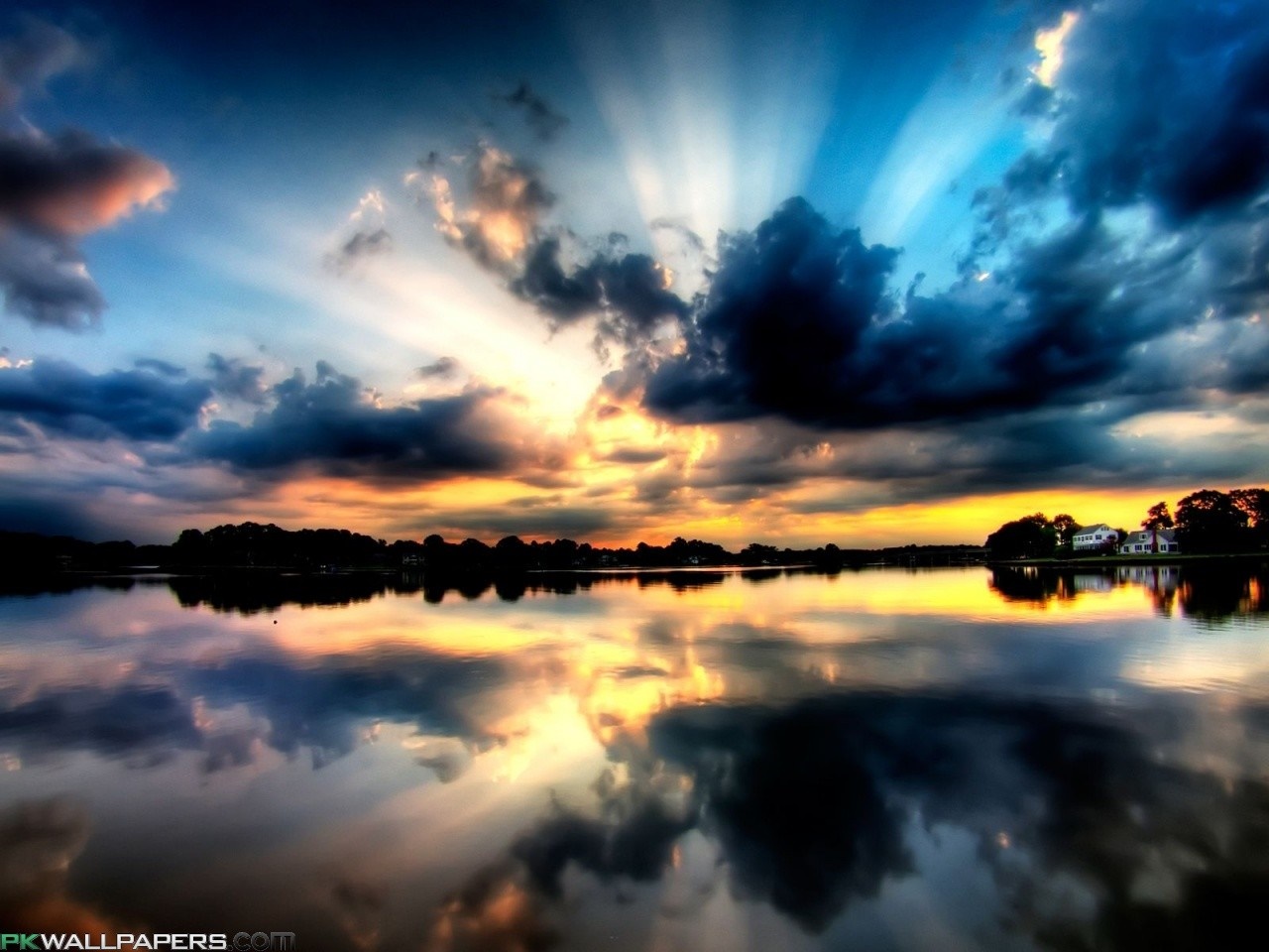 Sunset over a lake with dramatic clouds and reflections HD Wallpaper