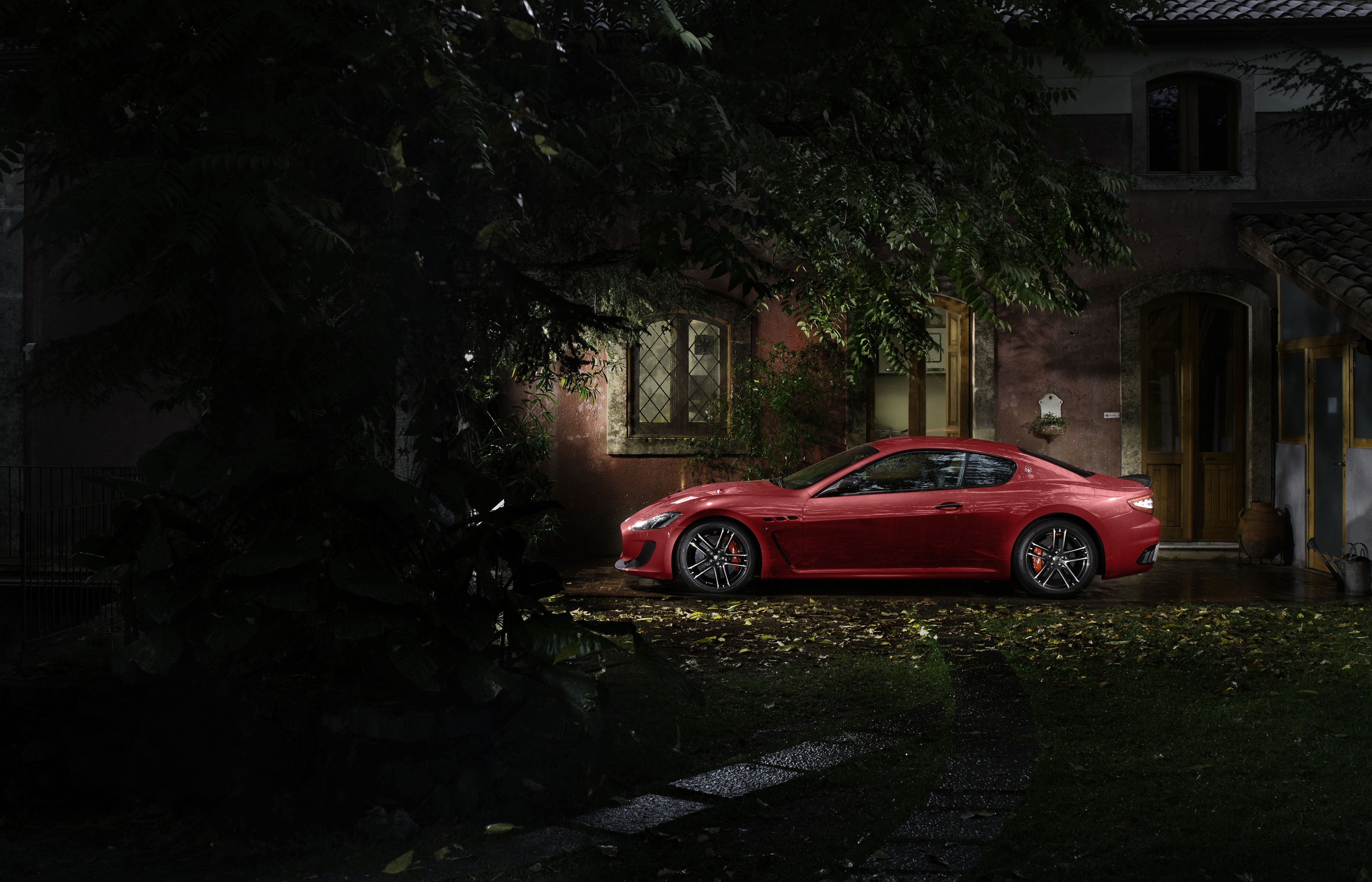 Red Maserati GranTurismo parked at night near a house HD Wallpaper
