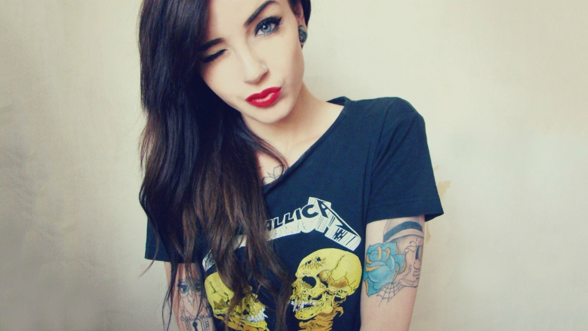 Woman with tattoos winking, wearing a Metallica t-shirt HD Wallpaper