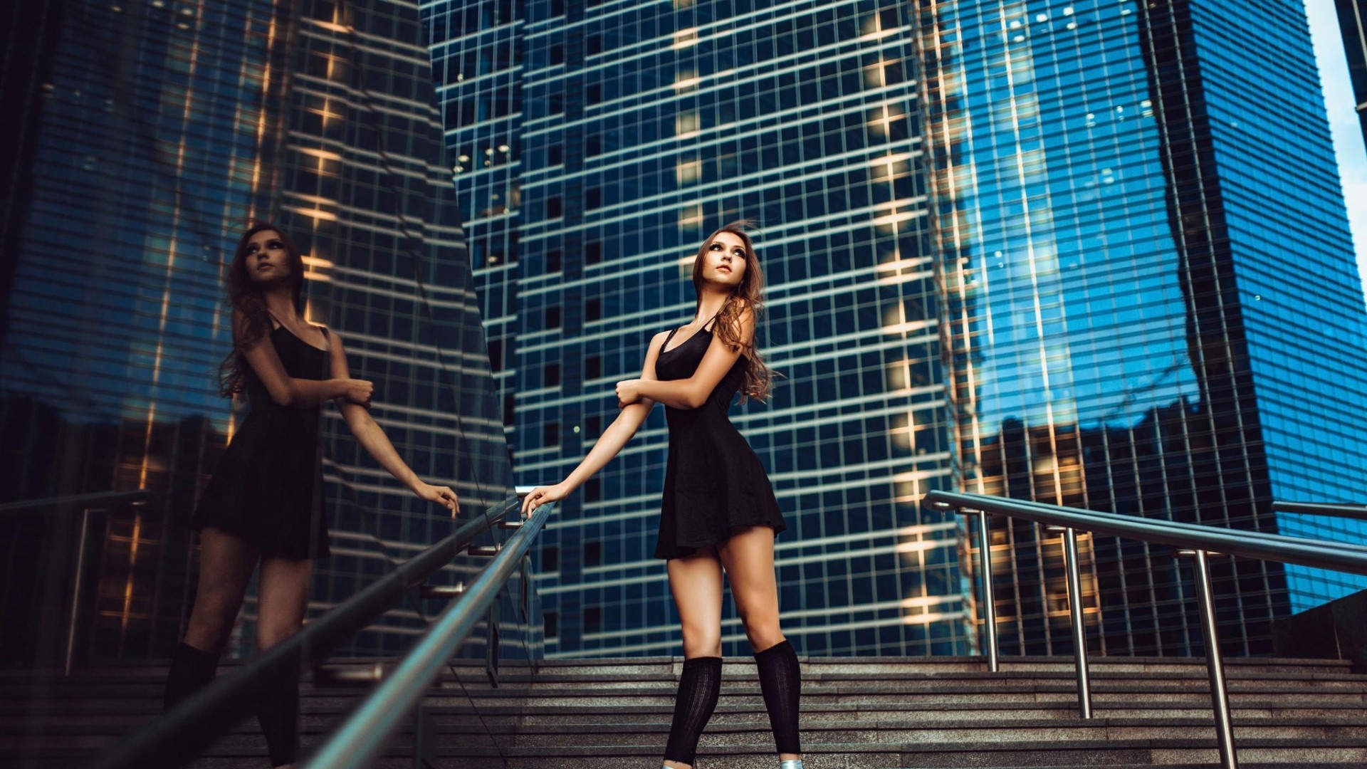 Woman in black dress on city stairs HD Wallpaper