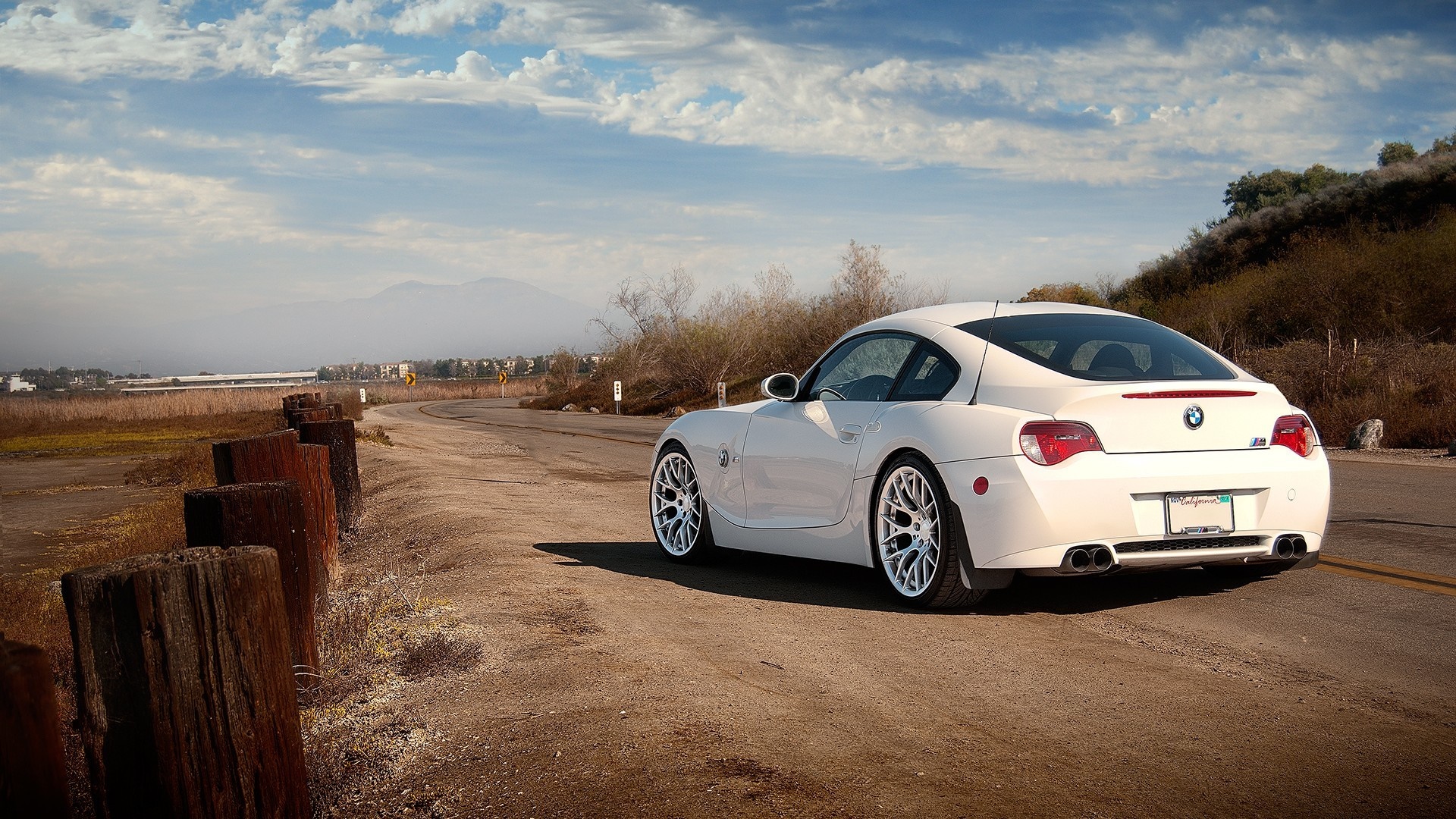 White BMW Z4 Coupe on a Winding Road HD Wallpaper