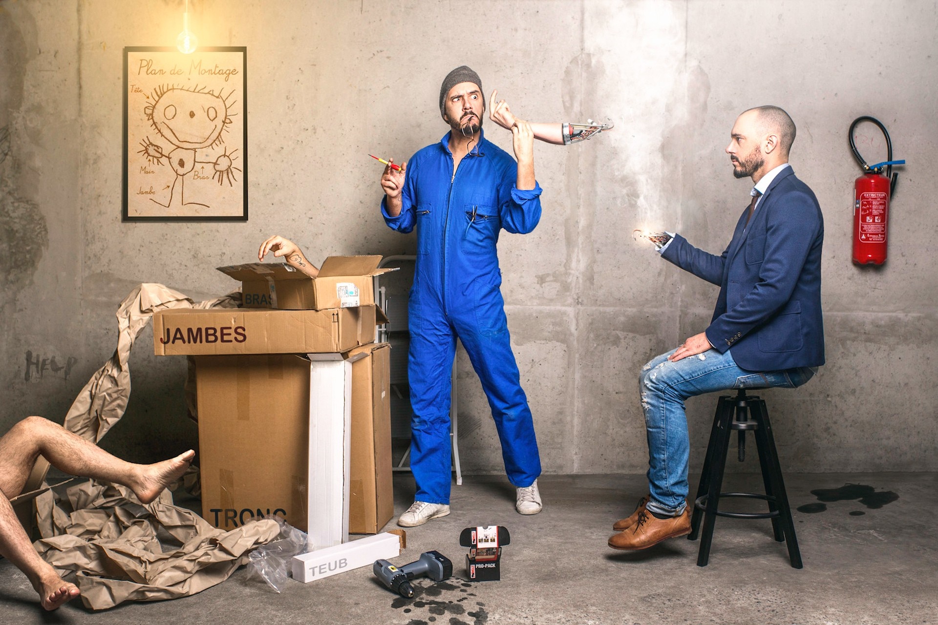 Men assembling a robot with a blueprint and tools HD Wallpaper