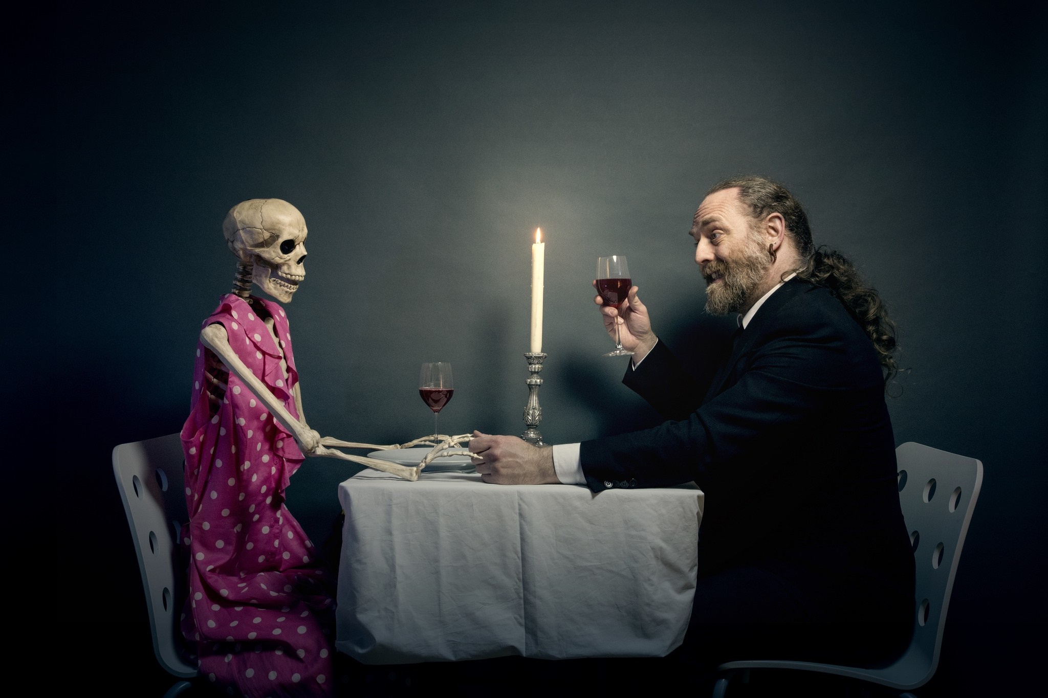 Man and skeleton having dinner with wine HD Wallpaper