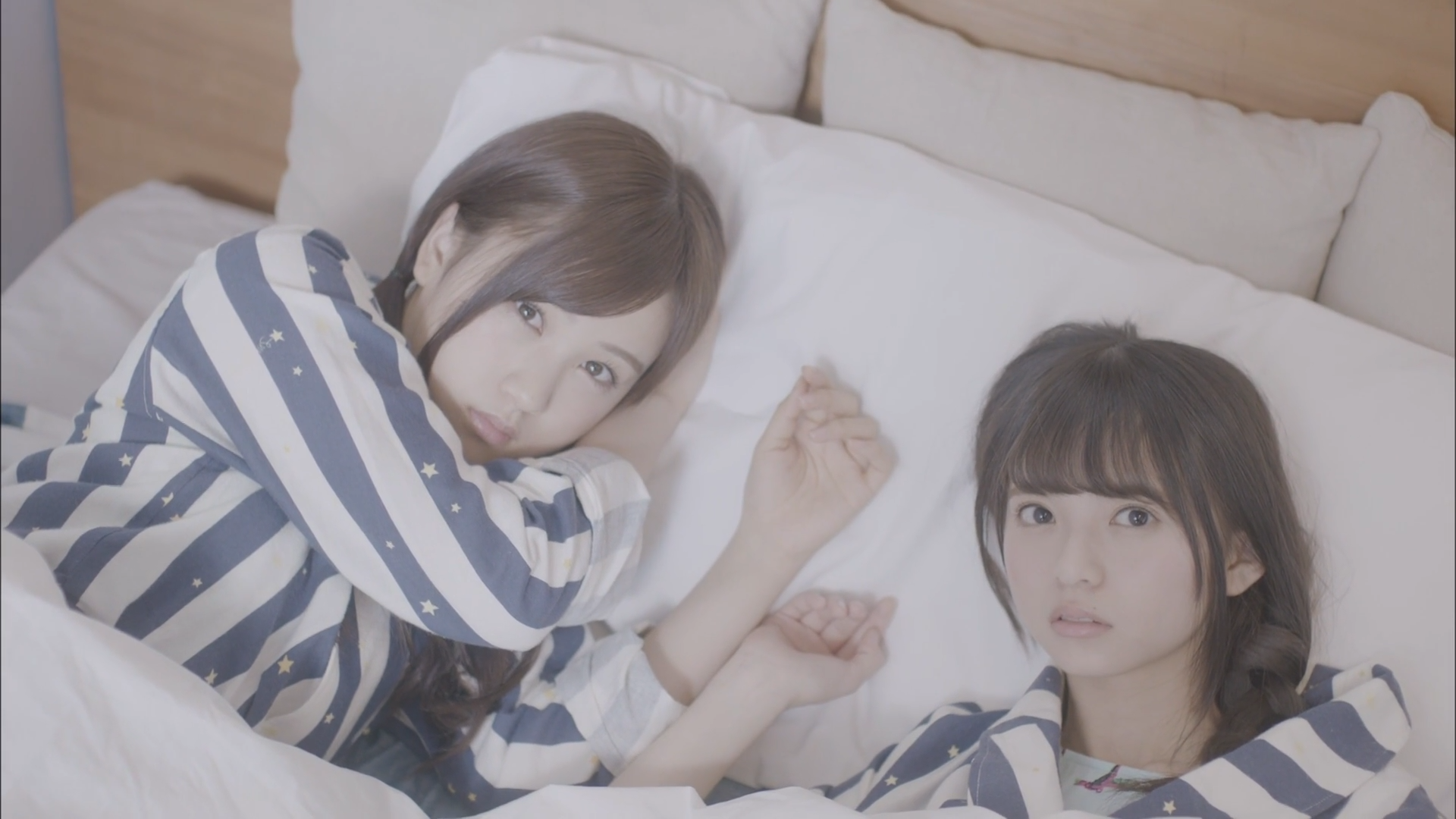 Two women in pajamas lying in bed HD Wallpaper