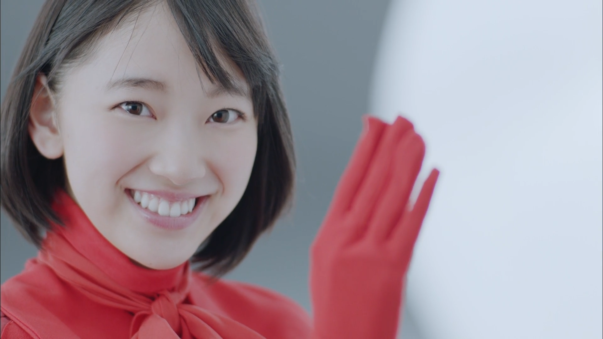Asian woman in red scarf and glove smiling HD Wallpaper