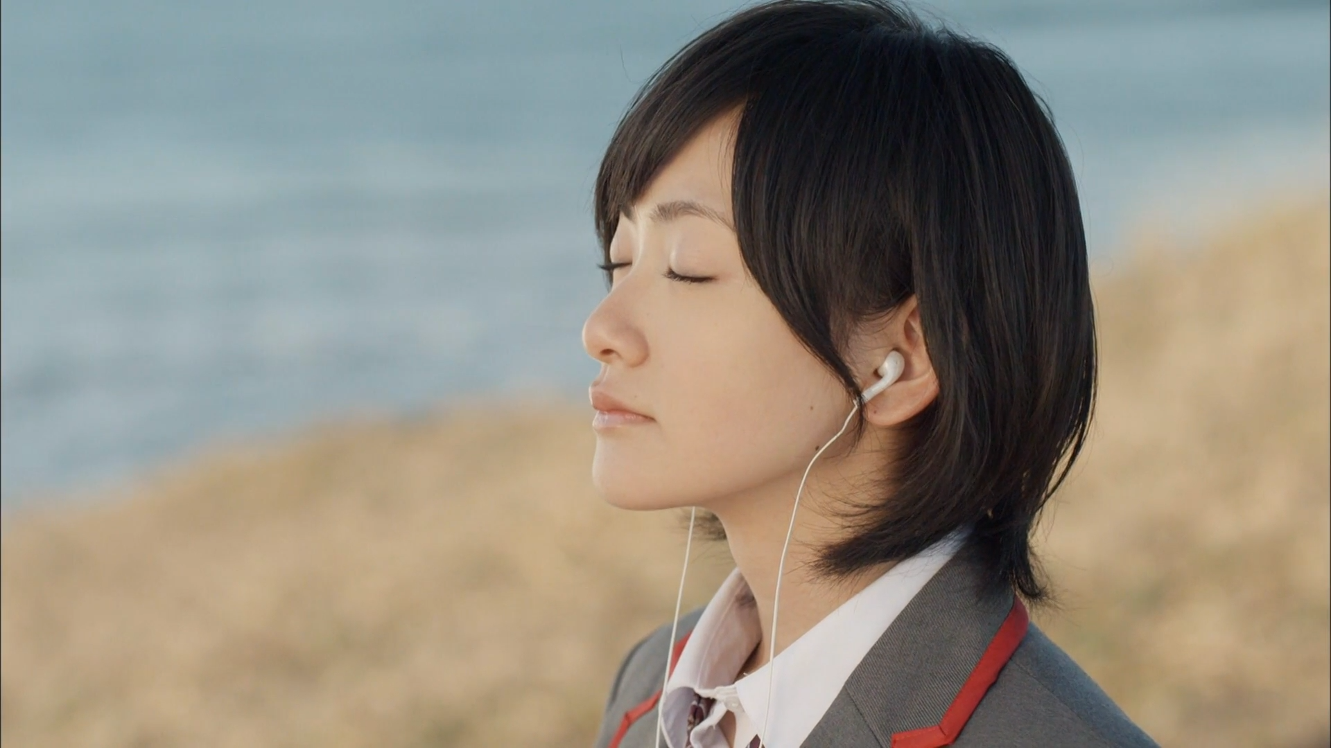 Woman wearing headphones with eyes closed HD Wallpaper