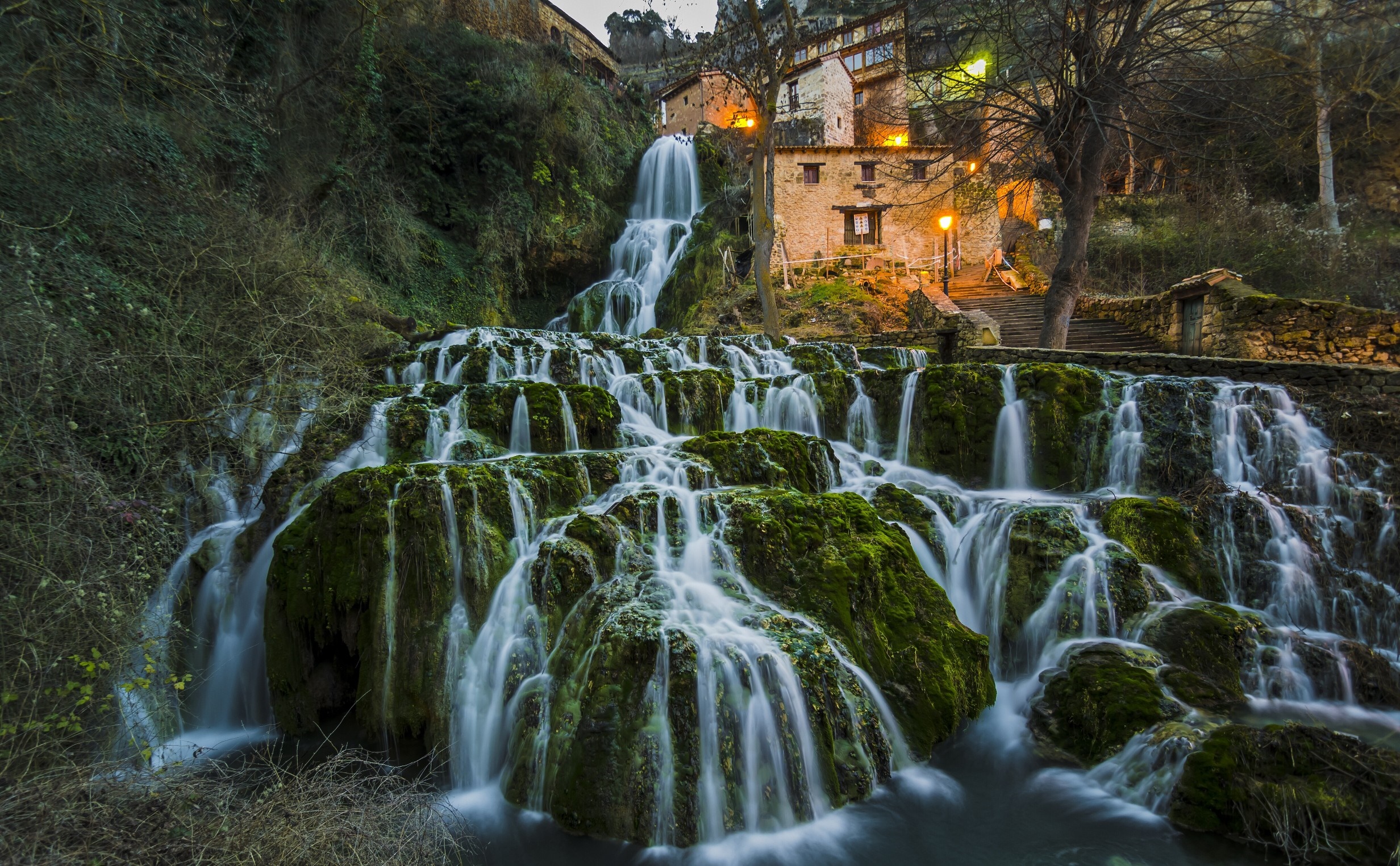 Waterfall cascading over mossy rocks near Orbaneja del Castillo, Spain HD Wallpaper