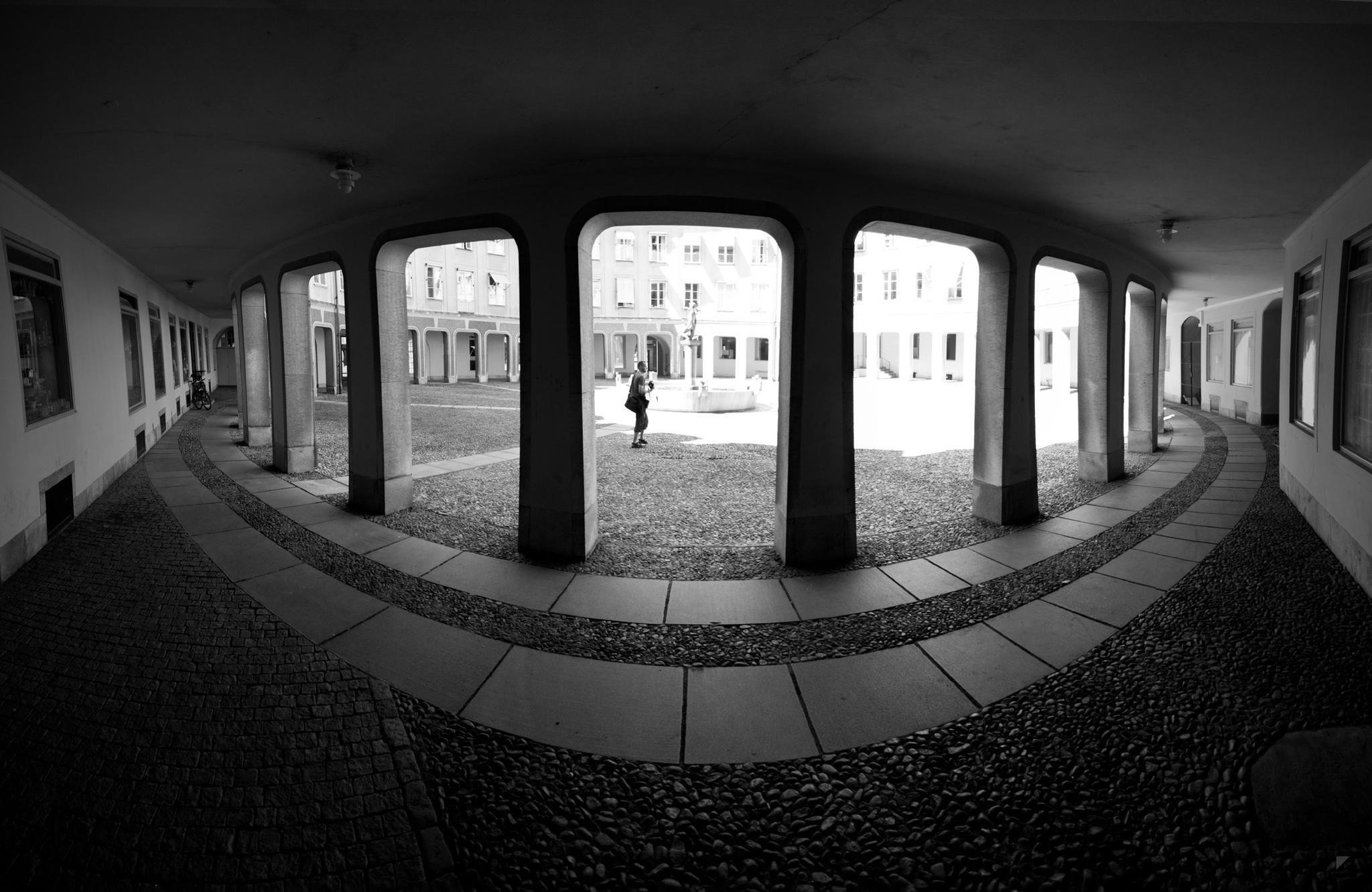Monochrome courtyard with arched colonnade and fountain HD Wallpaper
