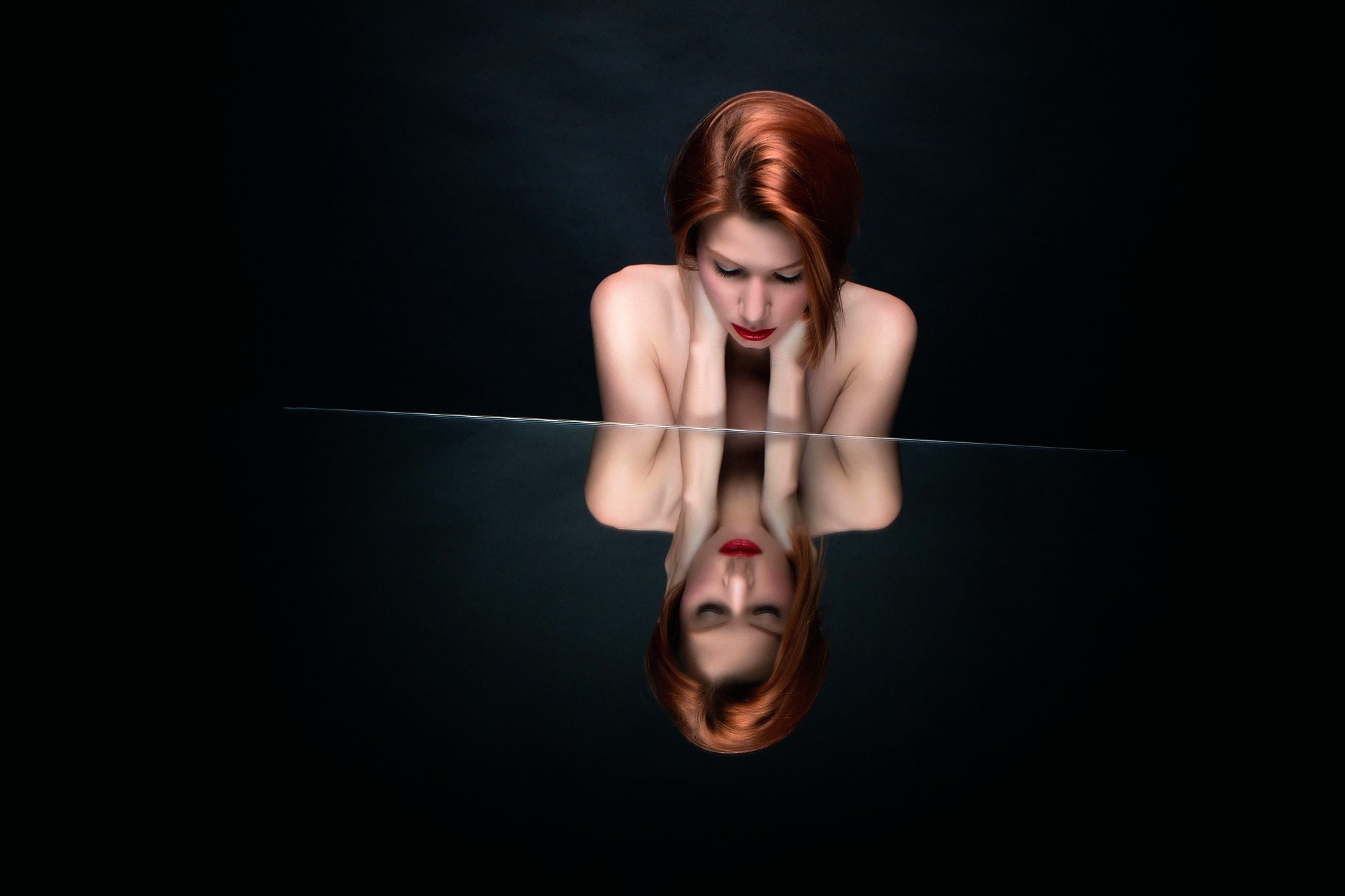 Woman with red hair looking at her reflection HD Wallpaper