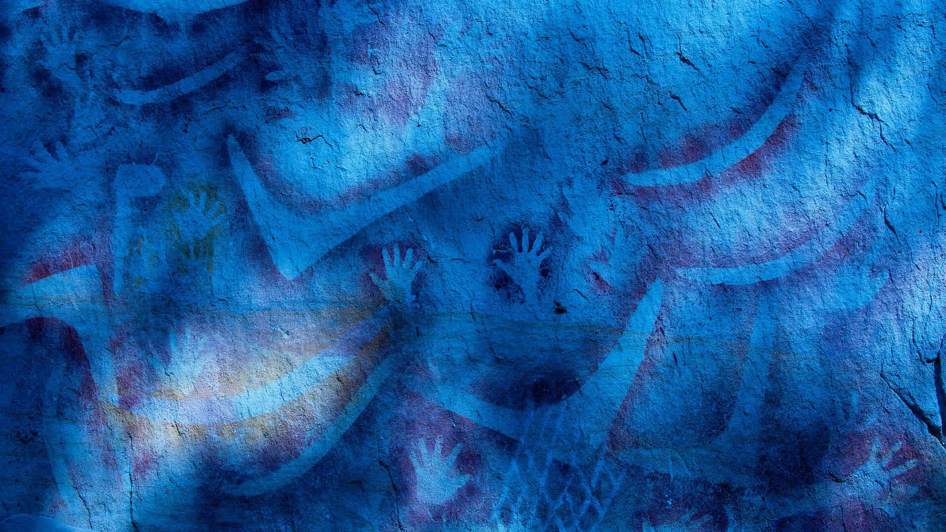 Blue cave painting with handprints and abstract shapes HD Wallpaper