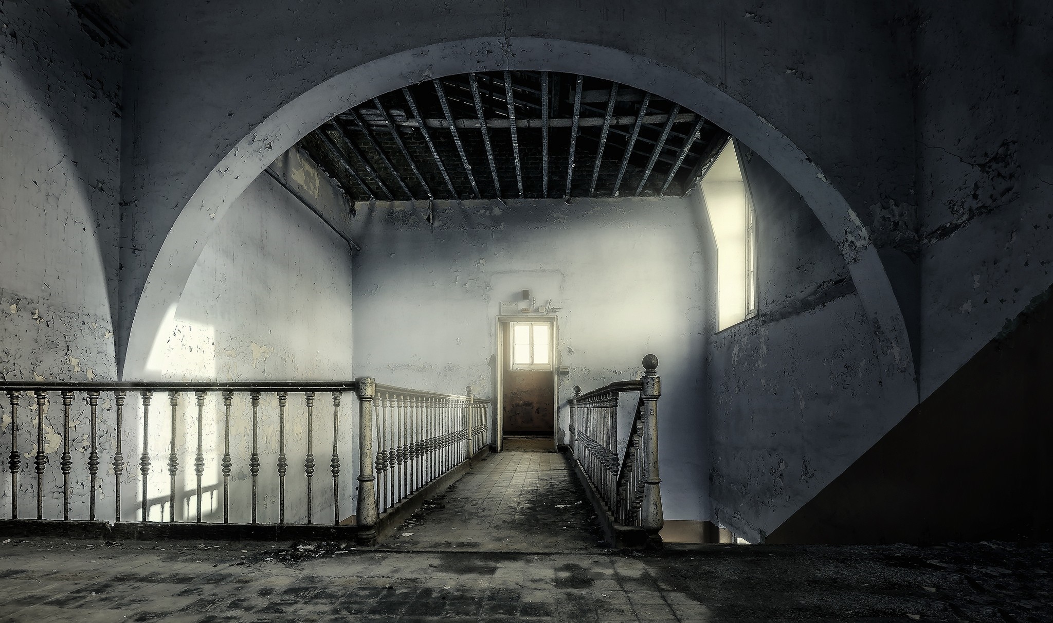 Abandoned building interior with archway and stairs HD Wallpaper
